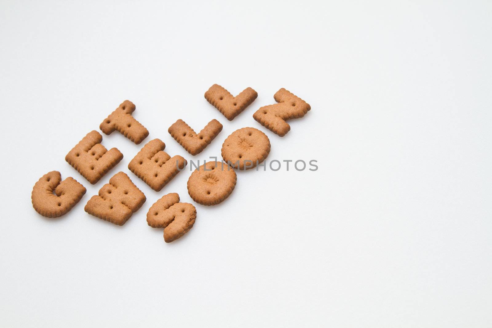 Slanting get well soon wording made by brown biscuits on white surface landscape orientation