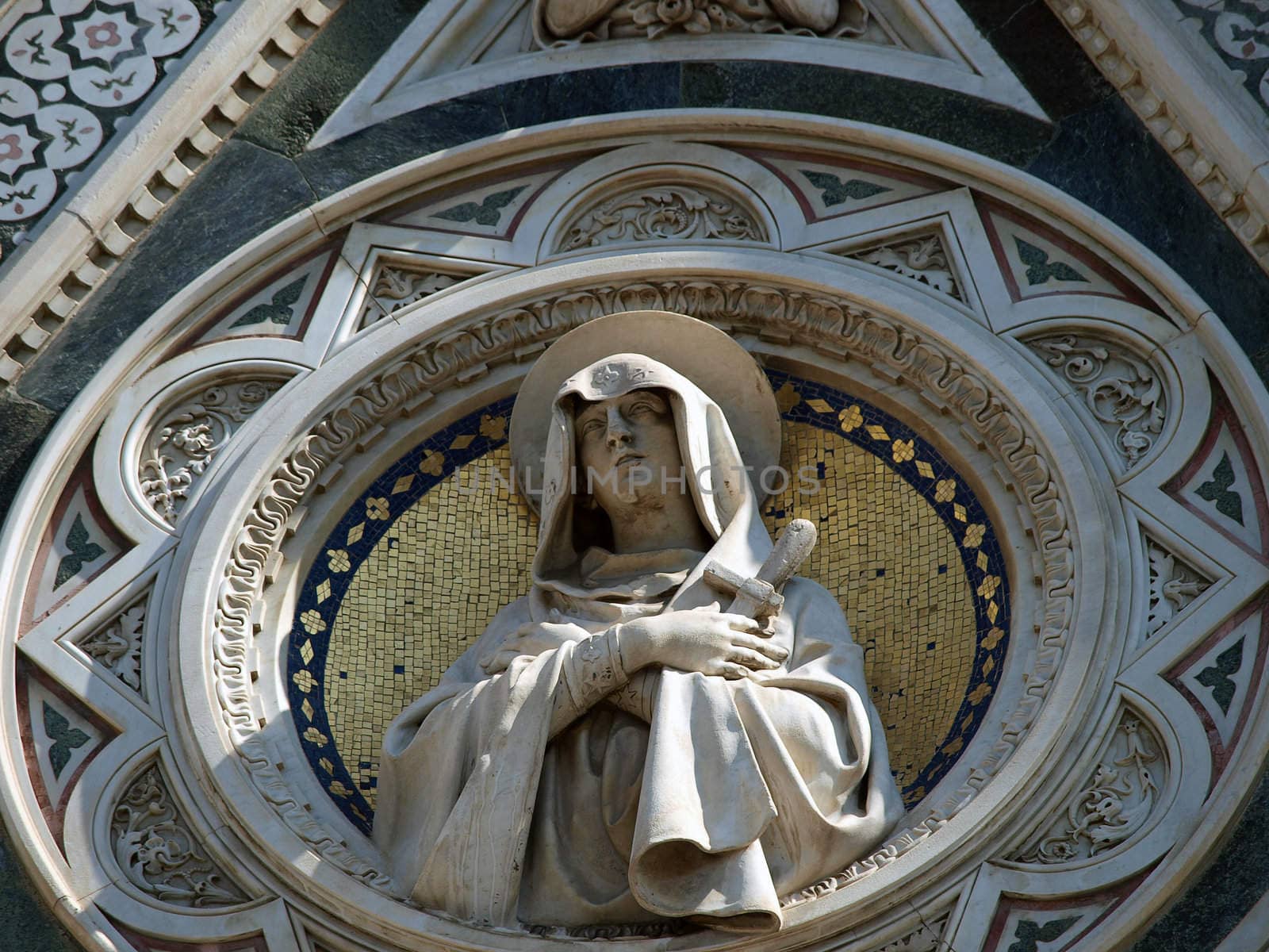 Florence - beautiful composition with  Virgin Mary above the portal on the facade of the Santa Maria del Fiore cathedral