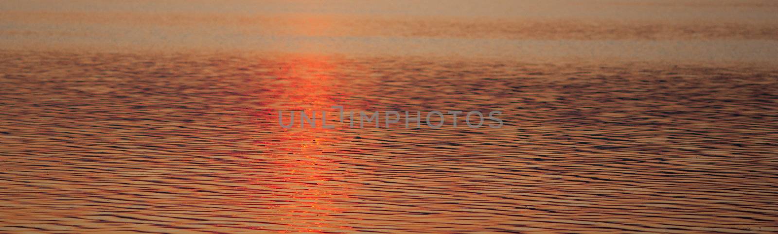 Colour, motion and pattern of a lake at sunset