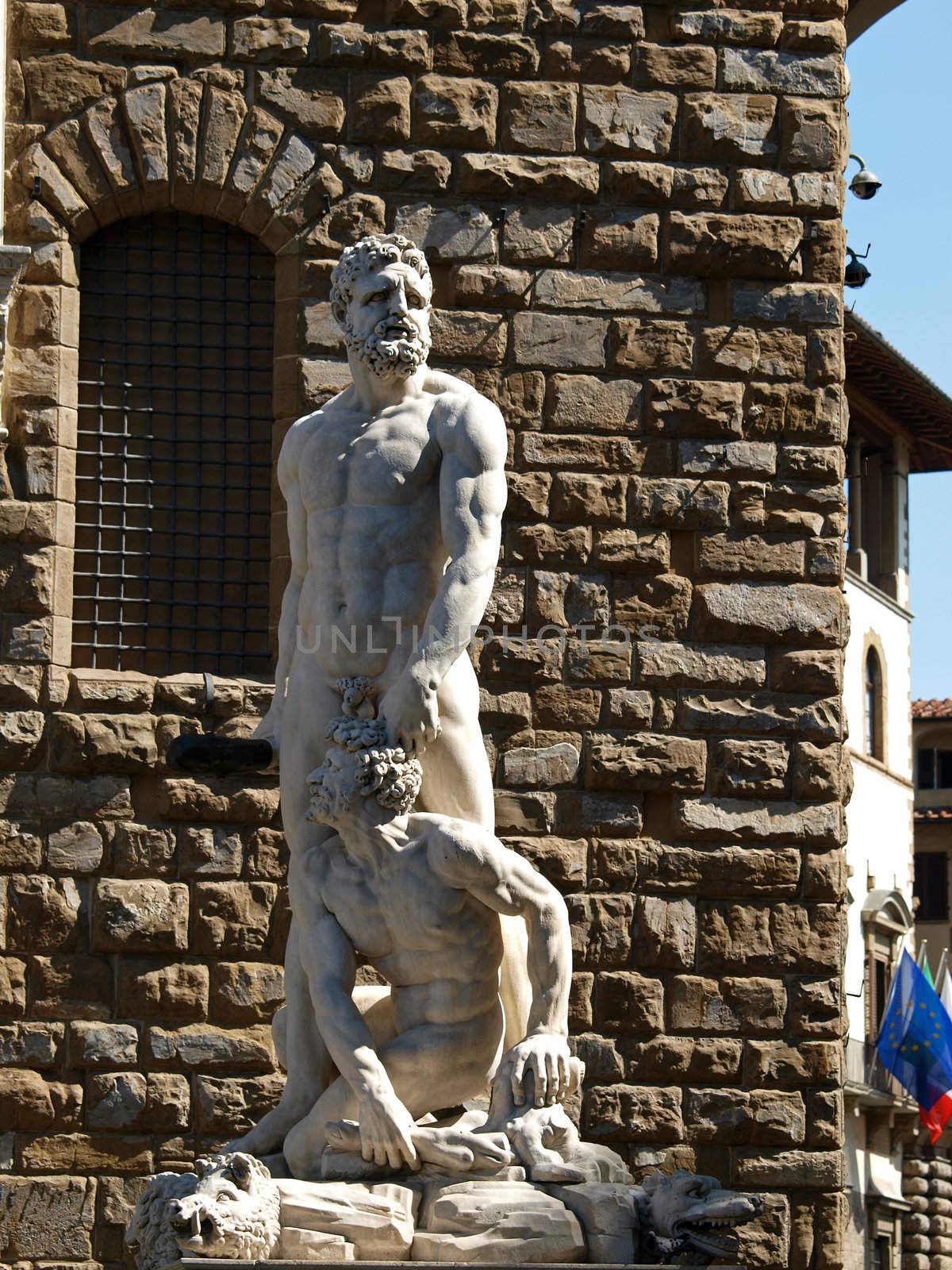 Florence - Sculpture Hercules and Cacus by Bandinelli. The white marble sculpture Hercules and Cacus is to the right of the entrance of the Palazzo Vecchio in the Piazza della Signoria, Florence, Italy.