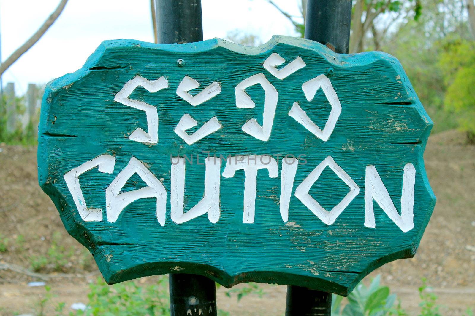 Caution Sign Thai and English  Language on  woodern sing