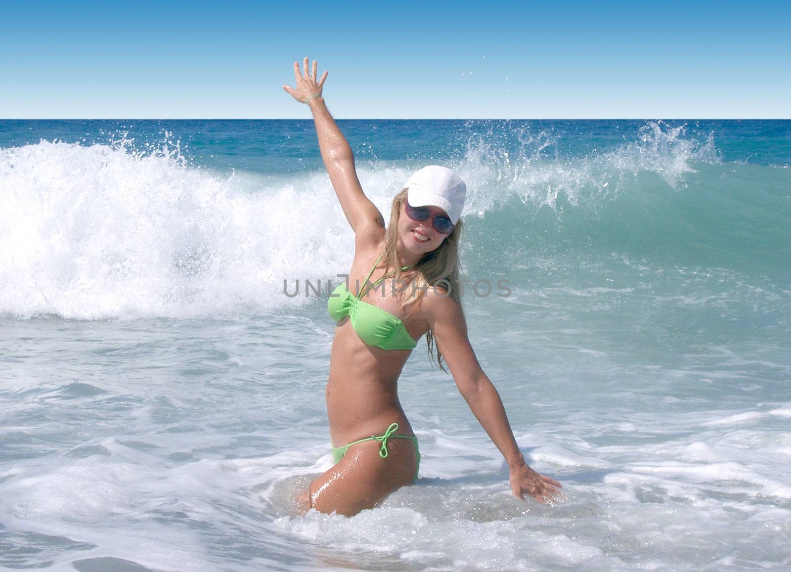 blond woman posing on the beach, standing with raised hand  by svtrotof