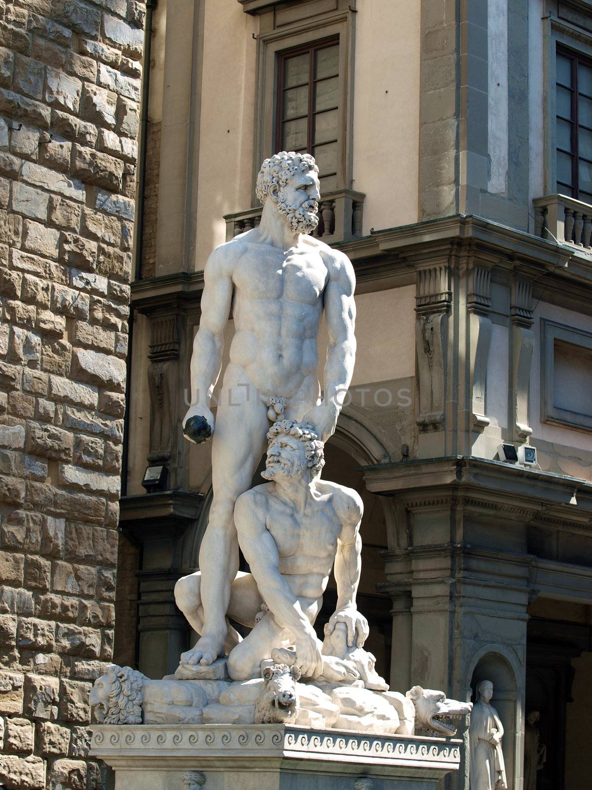 Florence - Sculpture Hercules and Cacus by Bandinelli. The white marble sculpture Hercules and Cacus is to the right of the entrance of the Palazzo Vecchio in the Piazza della Signoria, Florence, Italy.
