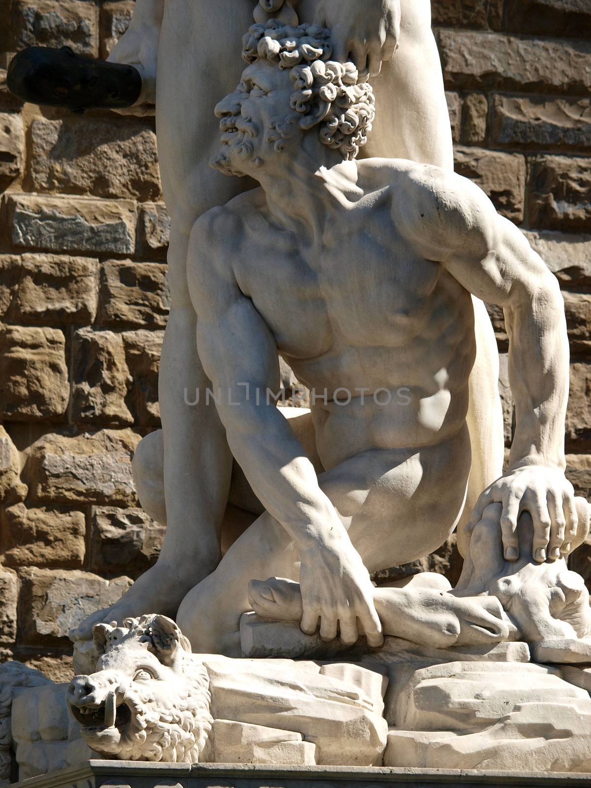 Florence - Sculpture Hercules and Cacus by Bandinelli. The white marble sculpture Hercules and Cacus is to the right of the entrance of the Palazzo Vecchio in the Piazza della Signoria, Florence, Italy.
