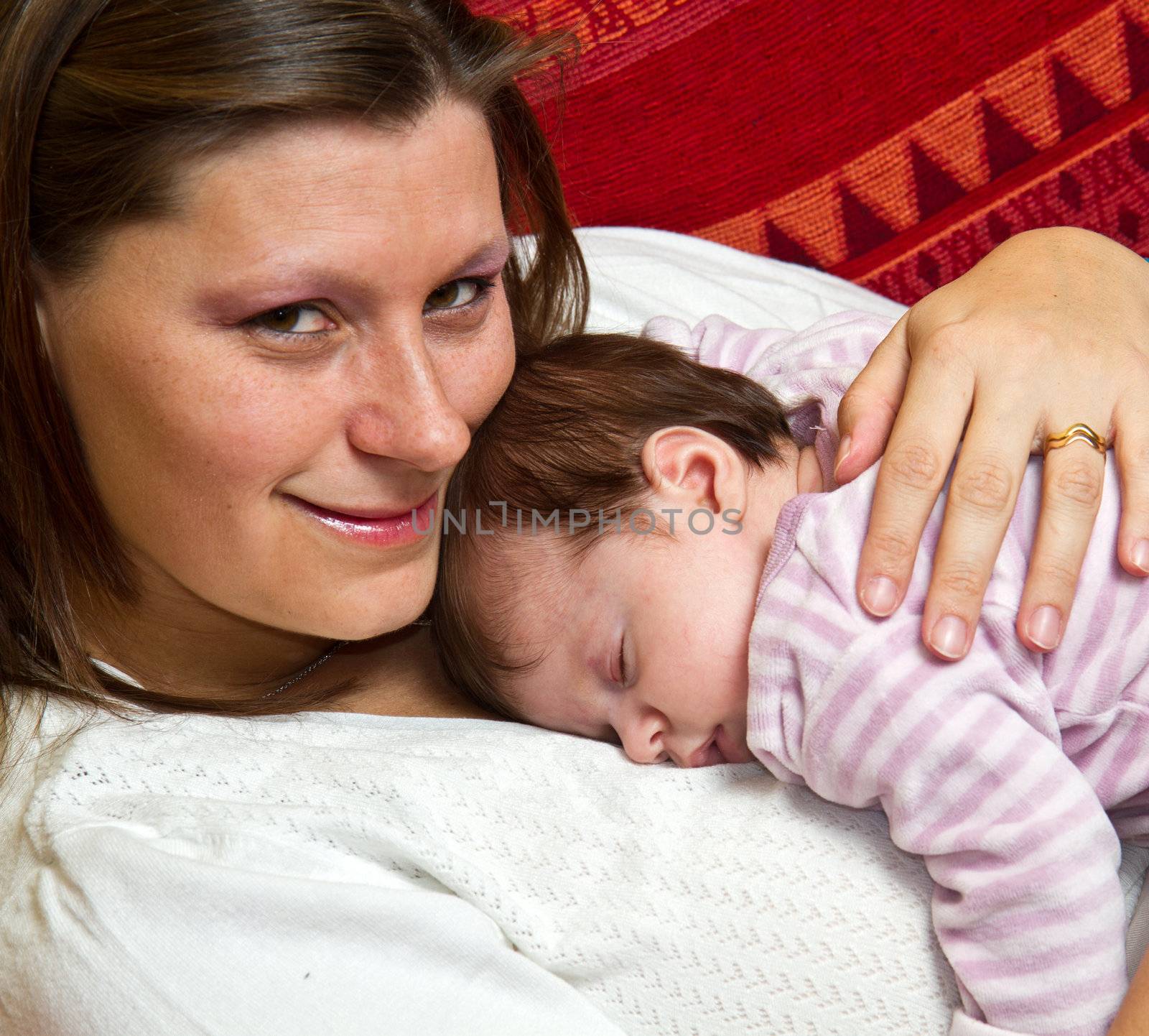 Mother embracing baby asleep by lsantilli