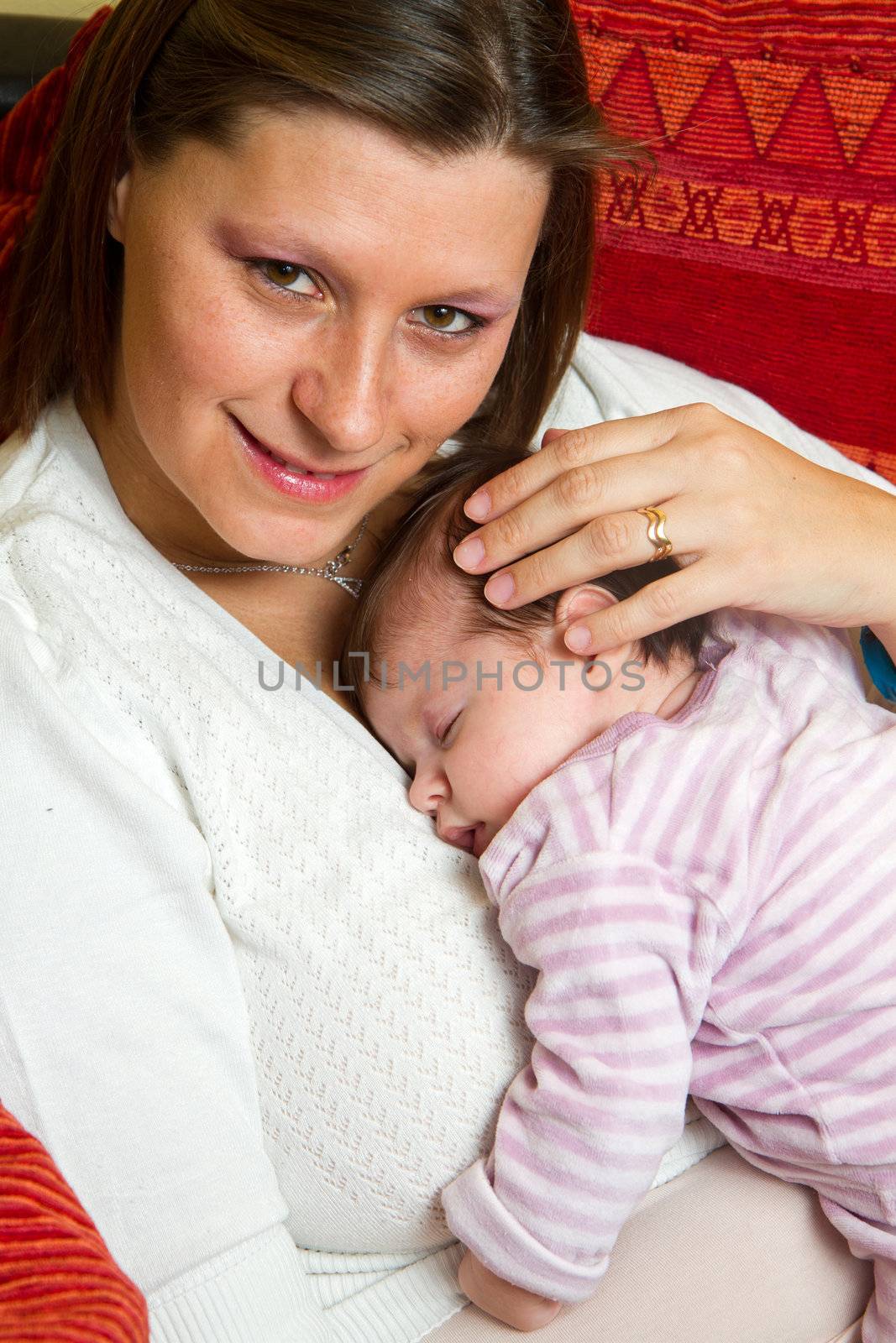 Mother embracing baby asleep