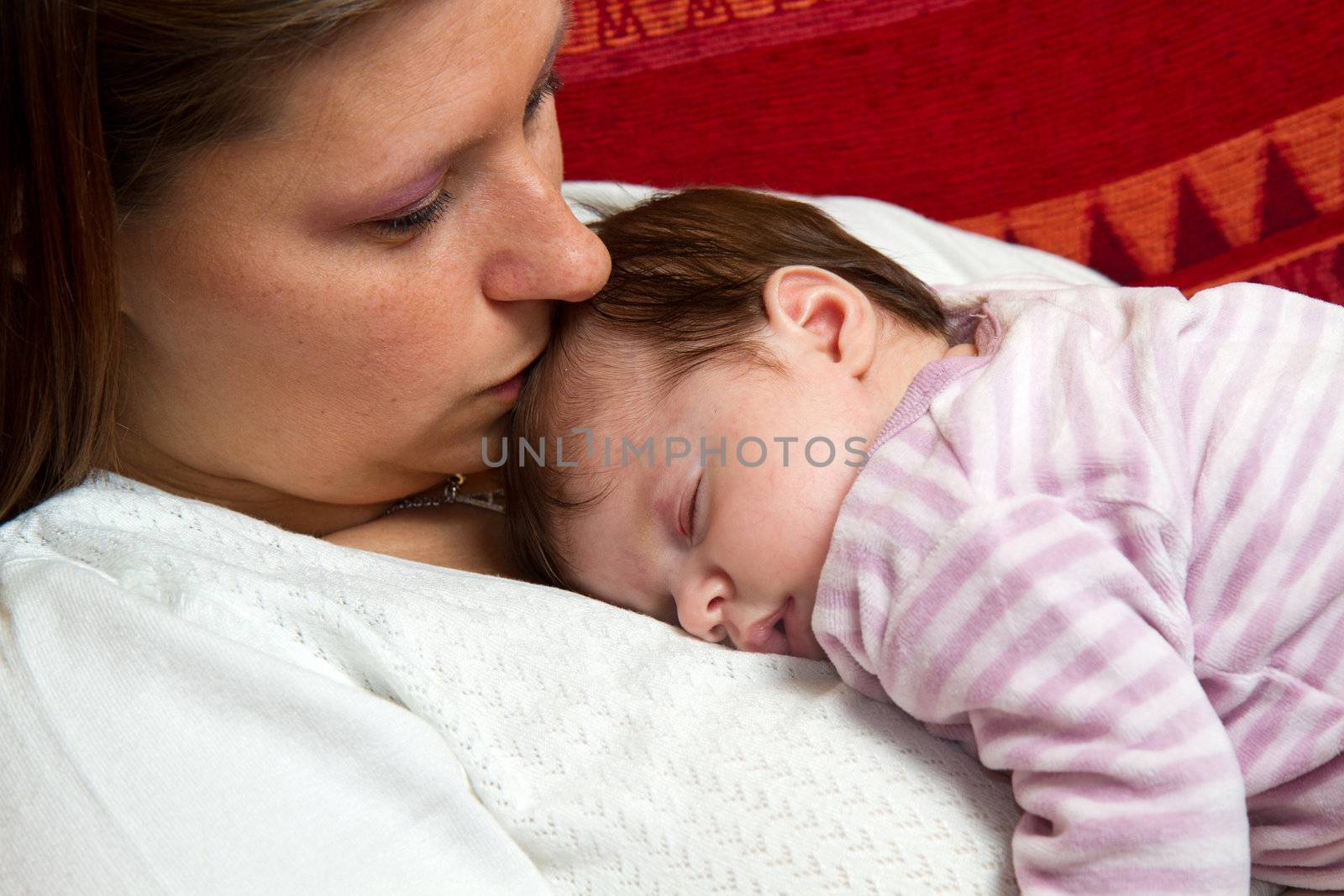 Mother kissing baby asleep