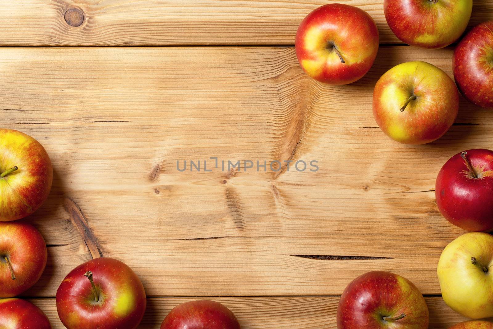 Apples on wooden table background. Fresh fruit backdrop with empty room for text