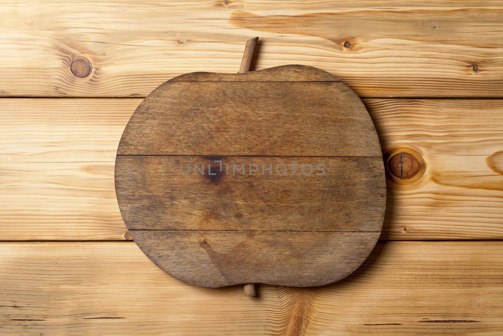Old wooden apple on wood table, natural patterns, top view