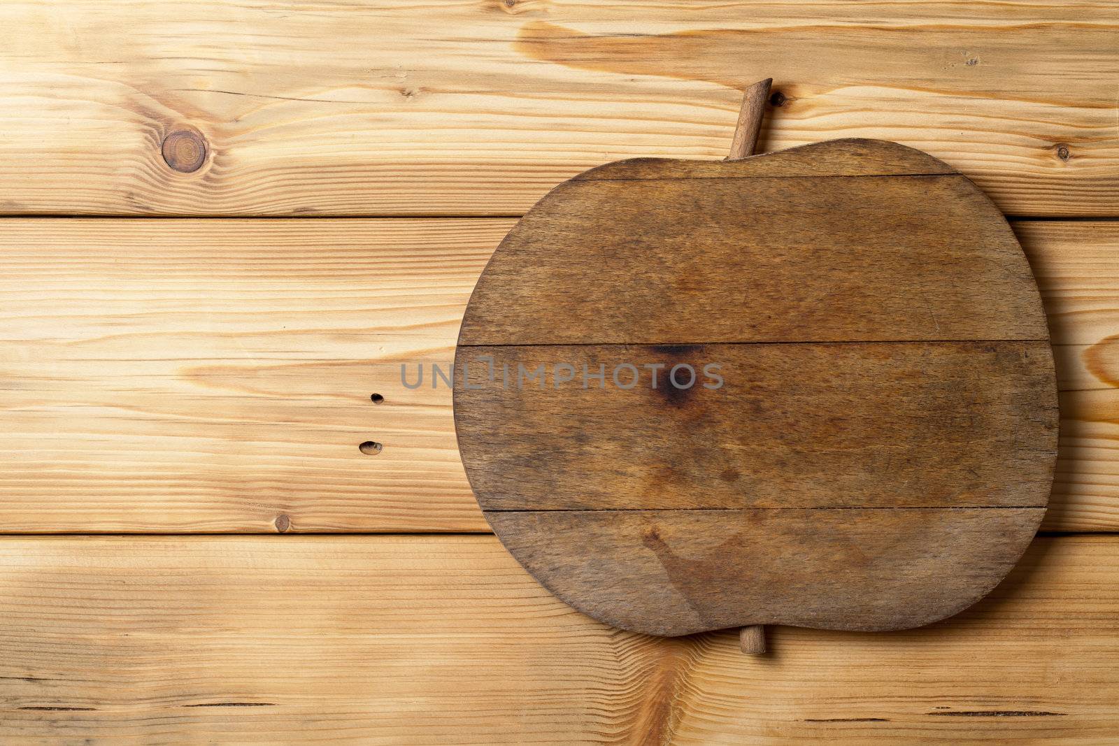 Old wooden apple on wood background with copy space, natural patterns