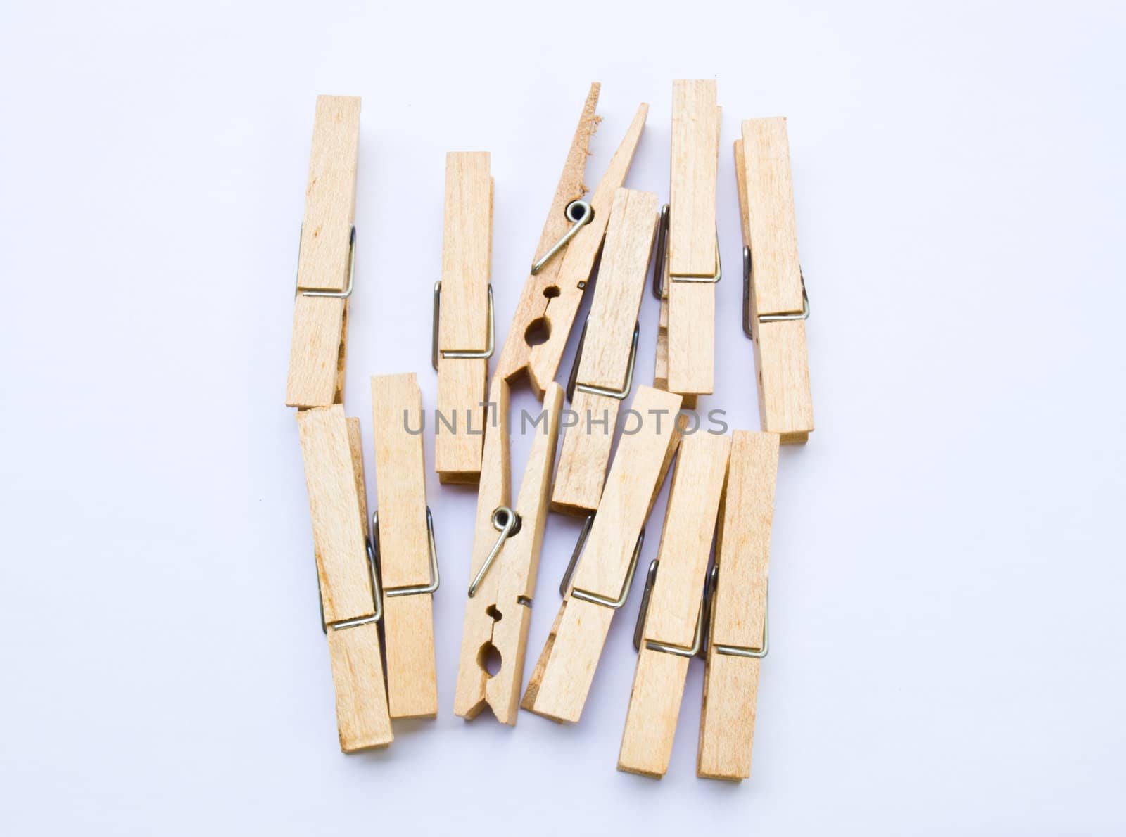 Wooden clothes clips isolated on white back ground by gururugu