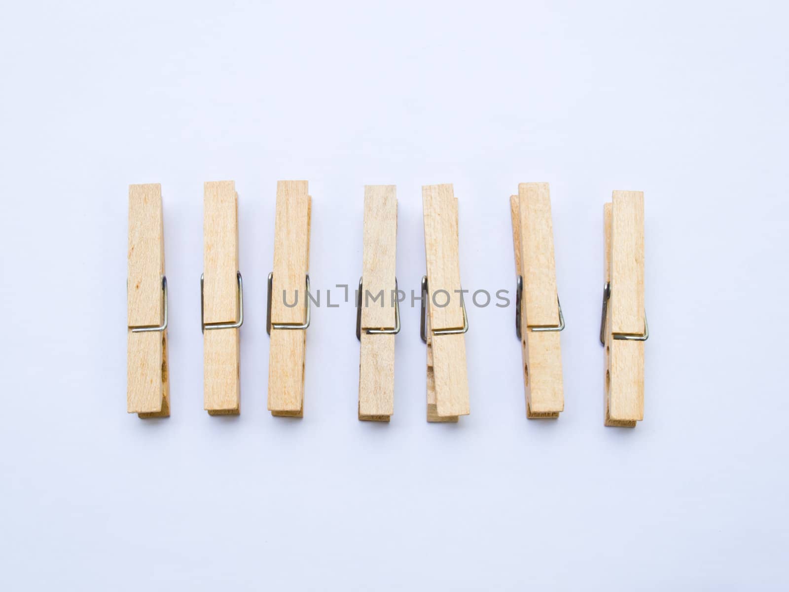 Wooden clothes clips isolated on white back ground by gururugu