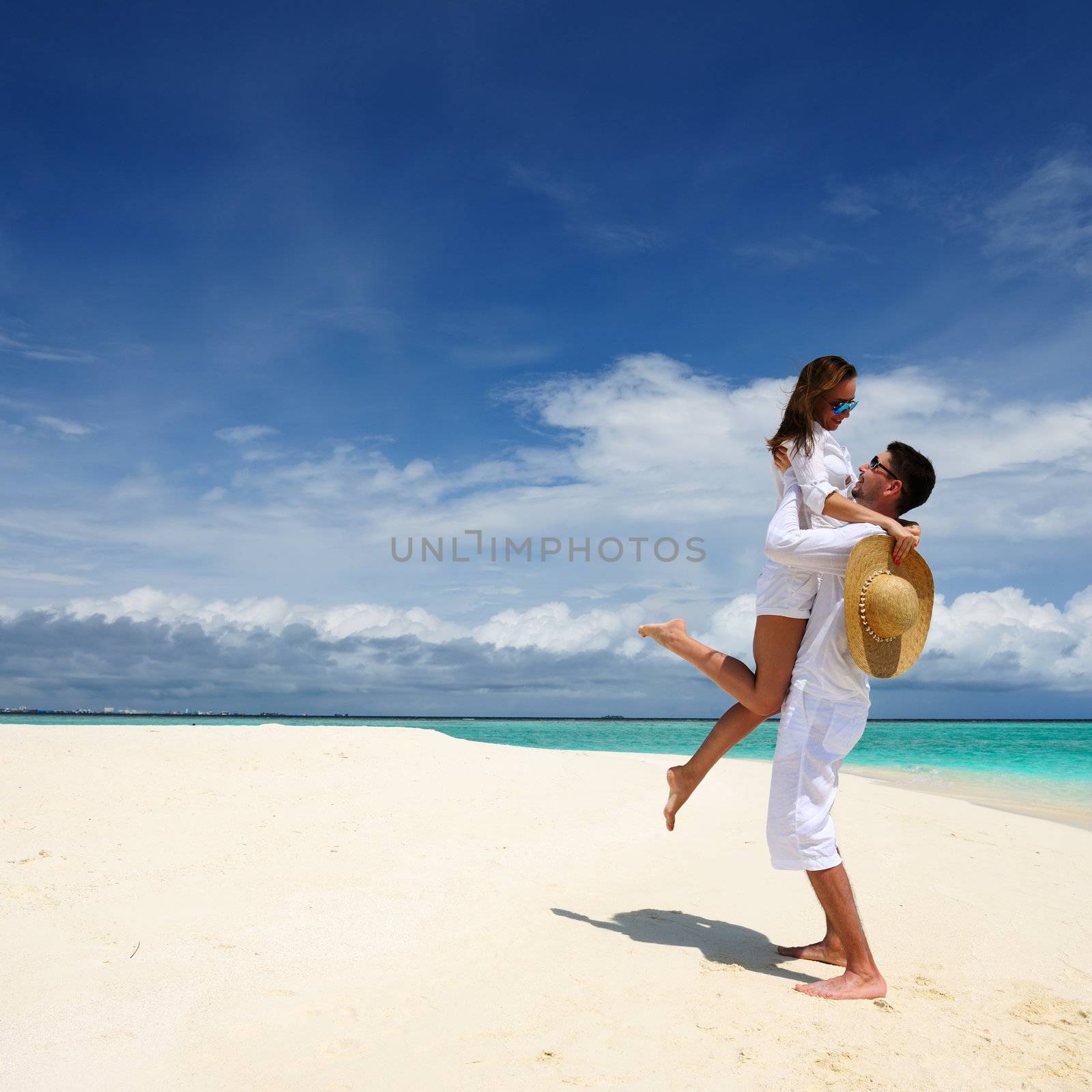 Couple on a beach at Maldives by haveseen