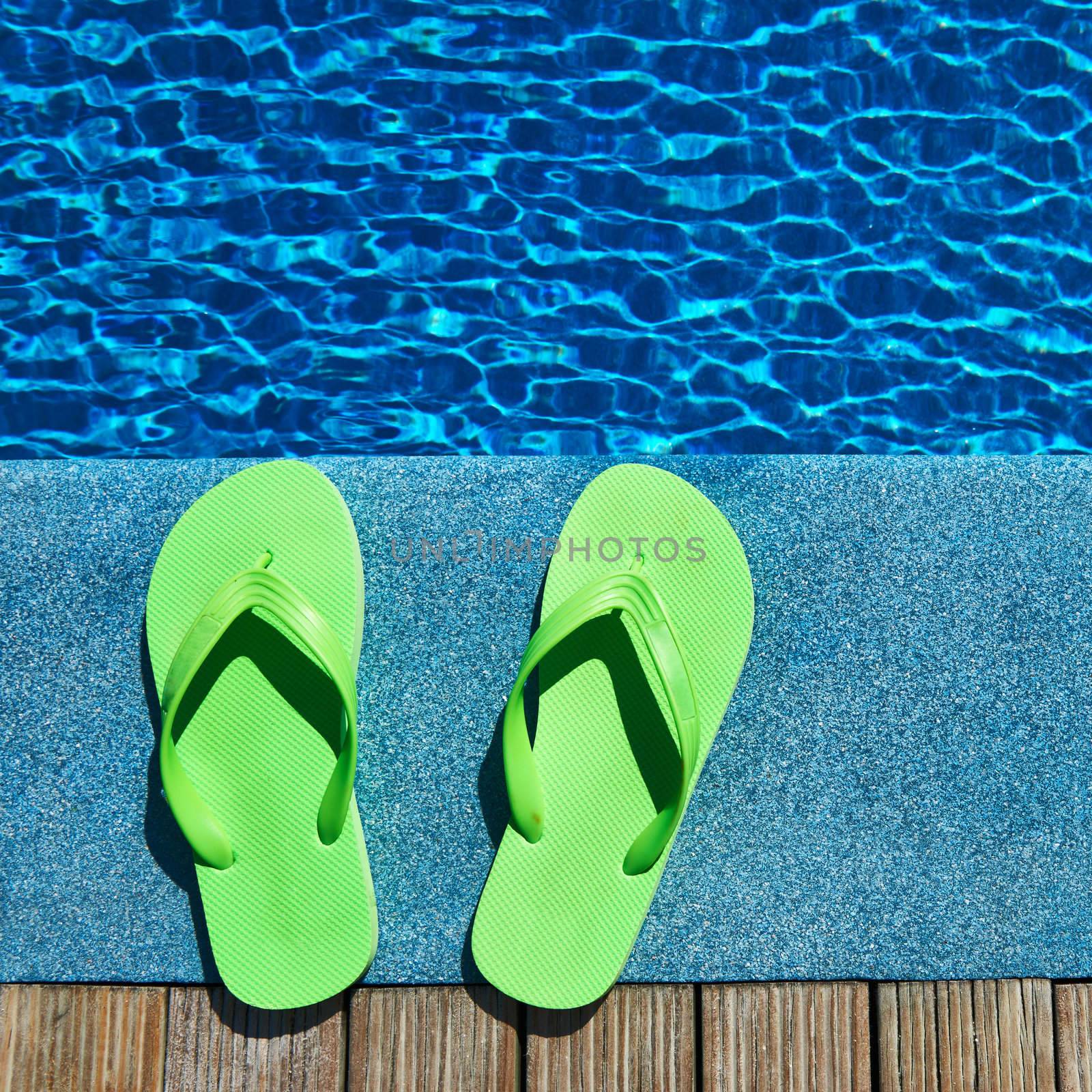 Sandals by a swimming pool  by haveseen