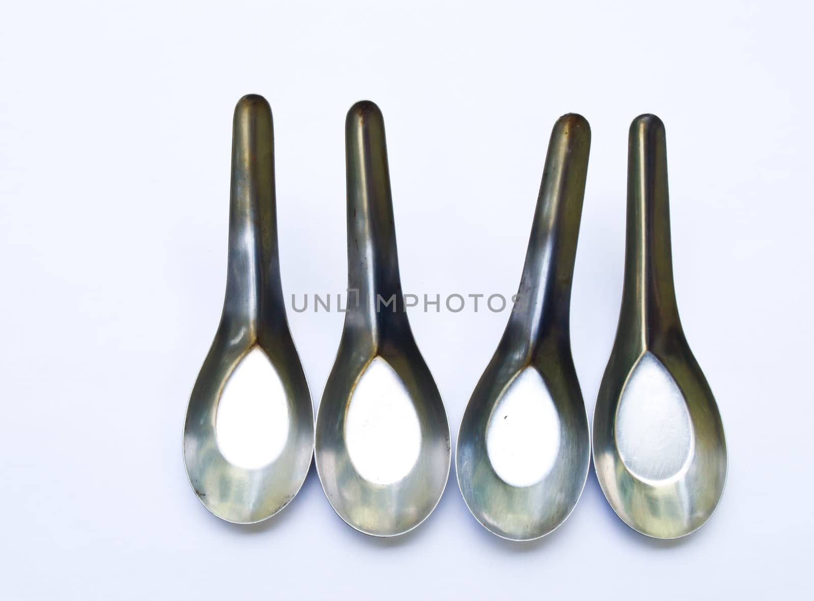 Used stainless stell spoons isolated on white background
