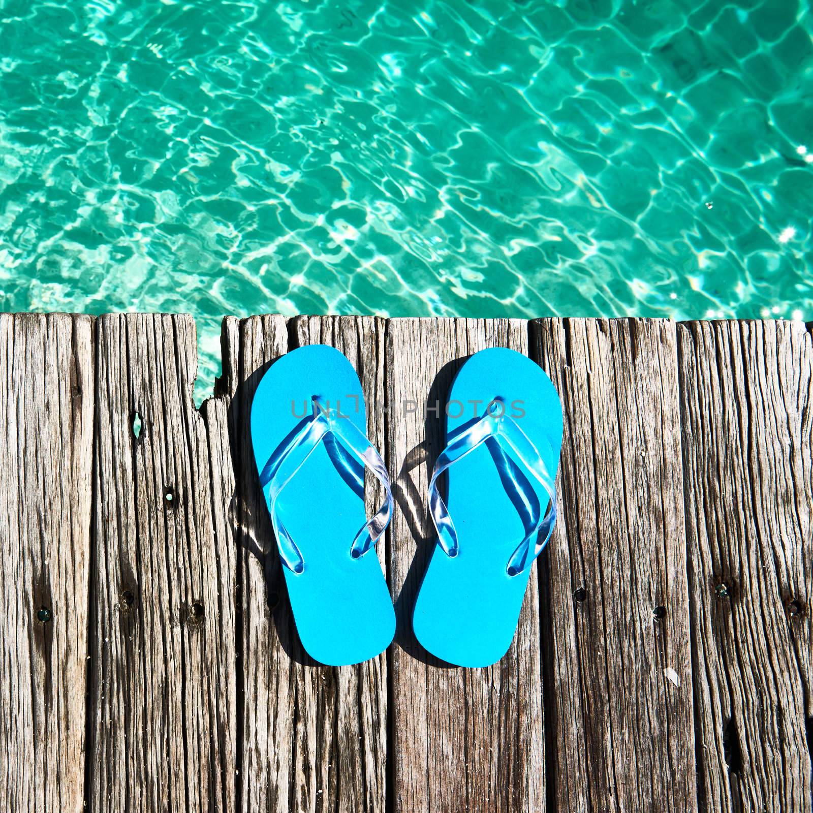 Slippers at jetty by the sea