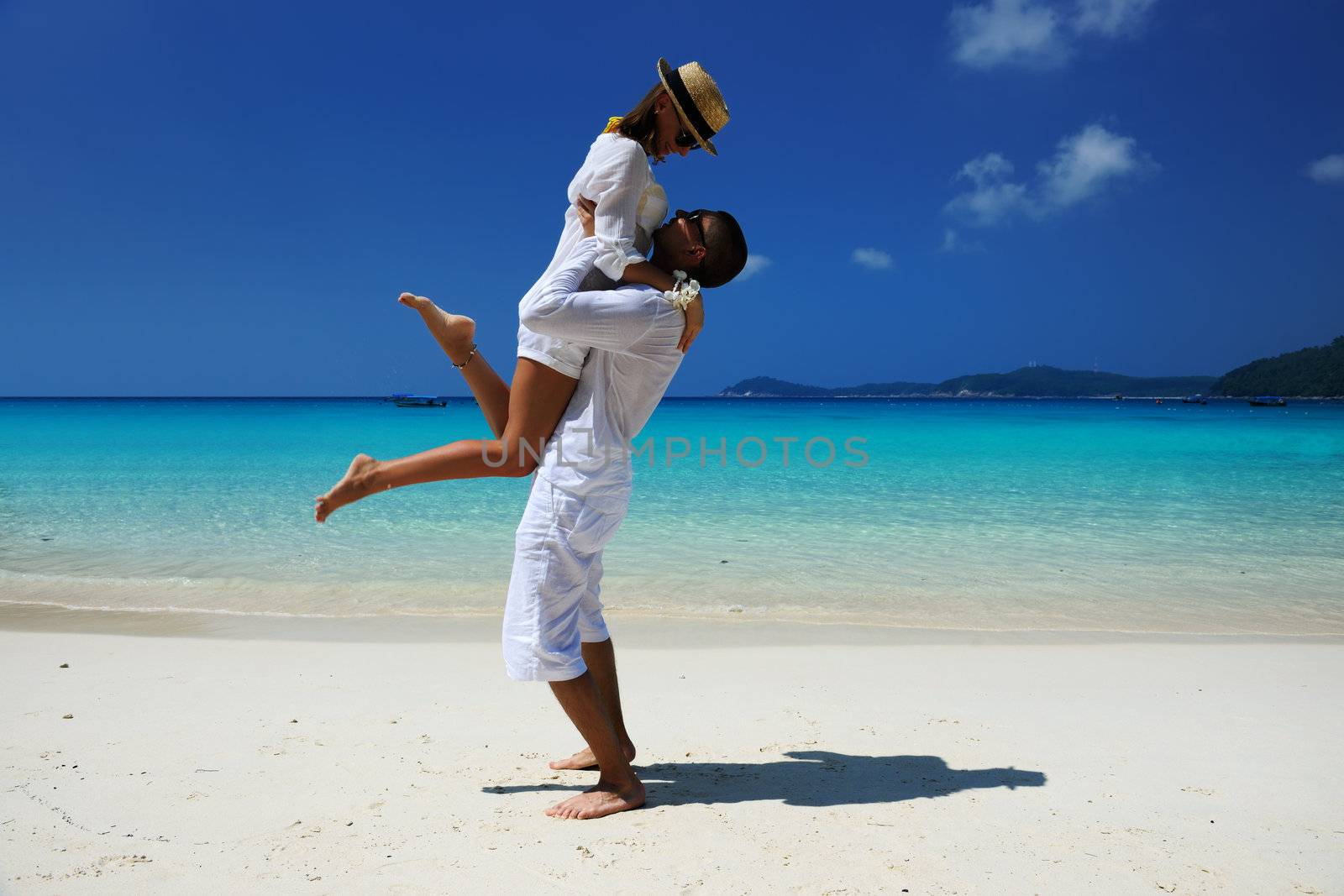 Couple in white on a tropical beach