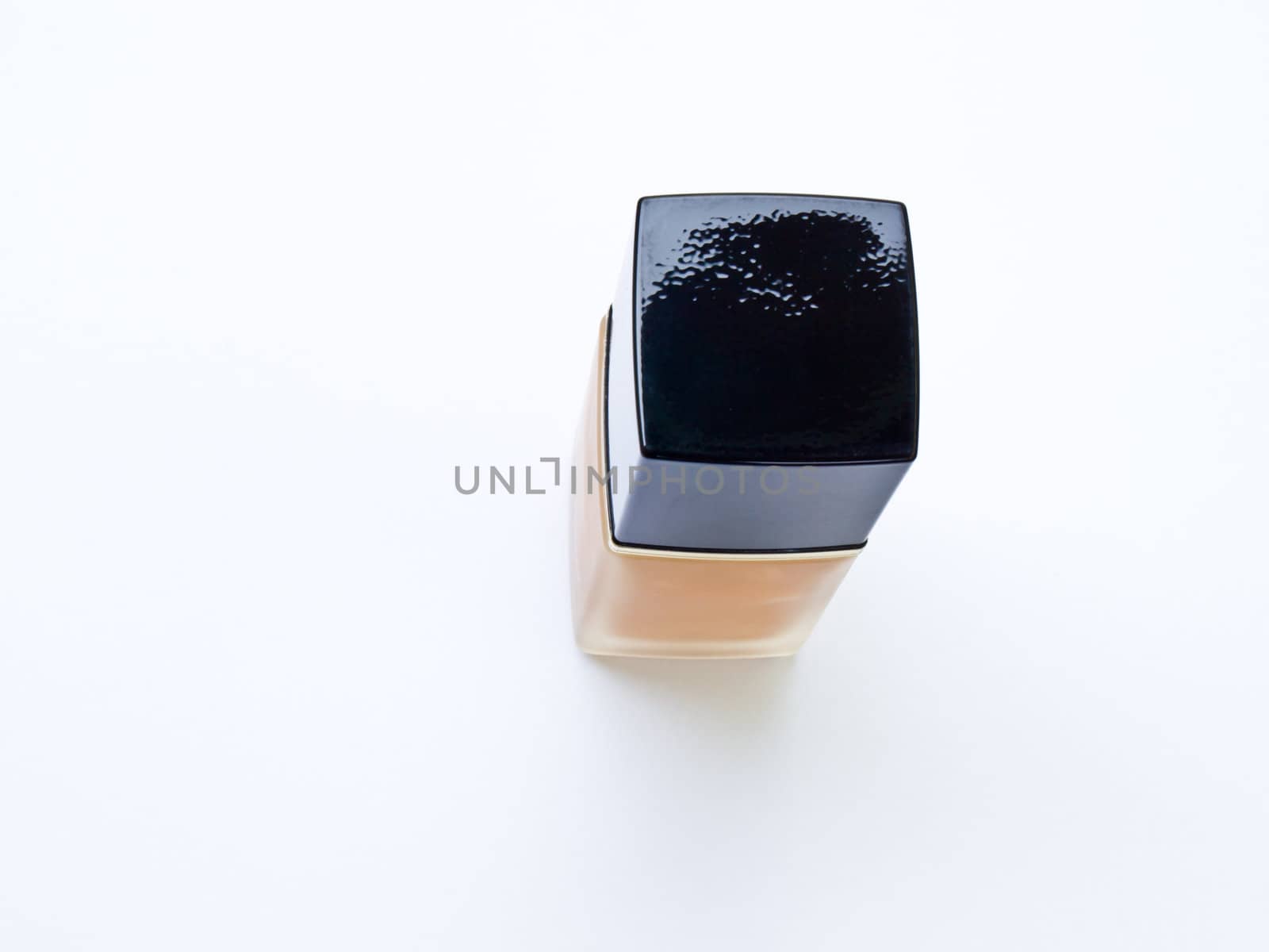 Bottle of cosmetic liquid foundation on white background.