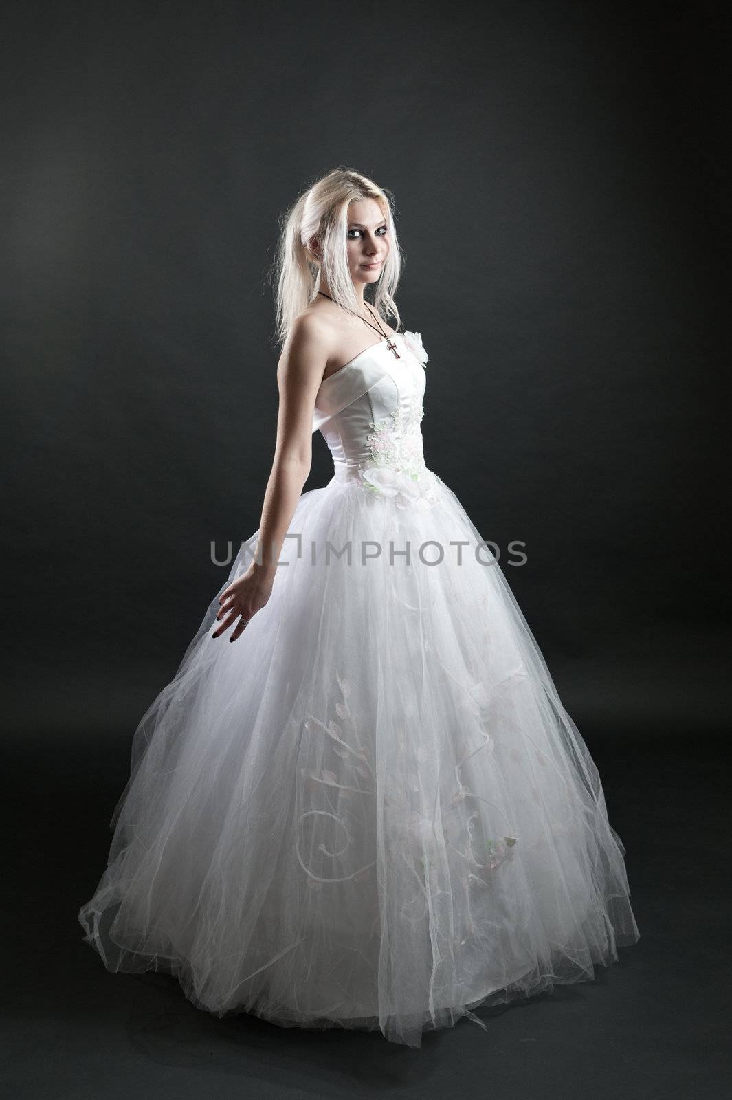 Beautiful girl in white dress on black background