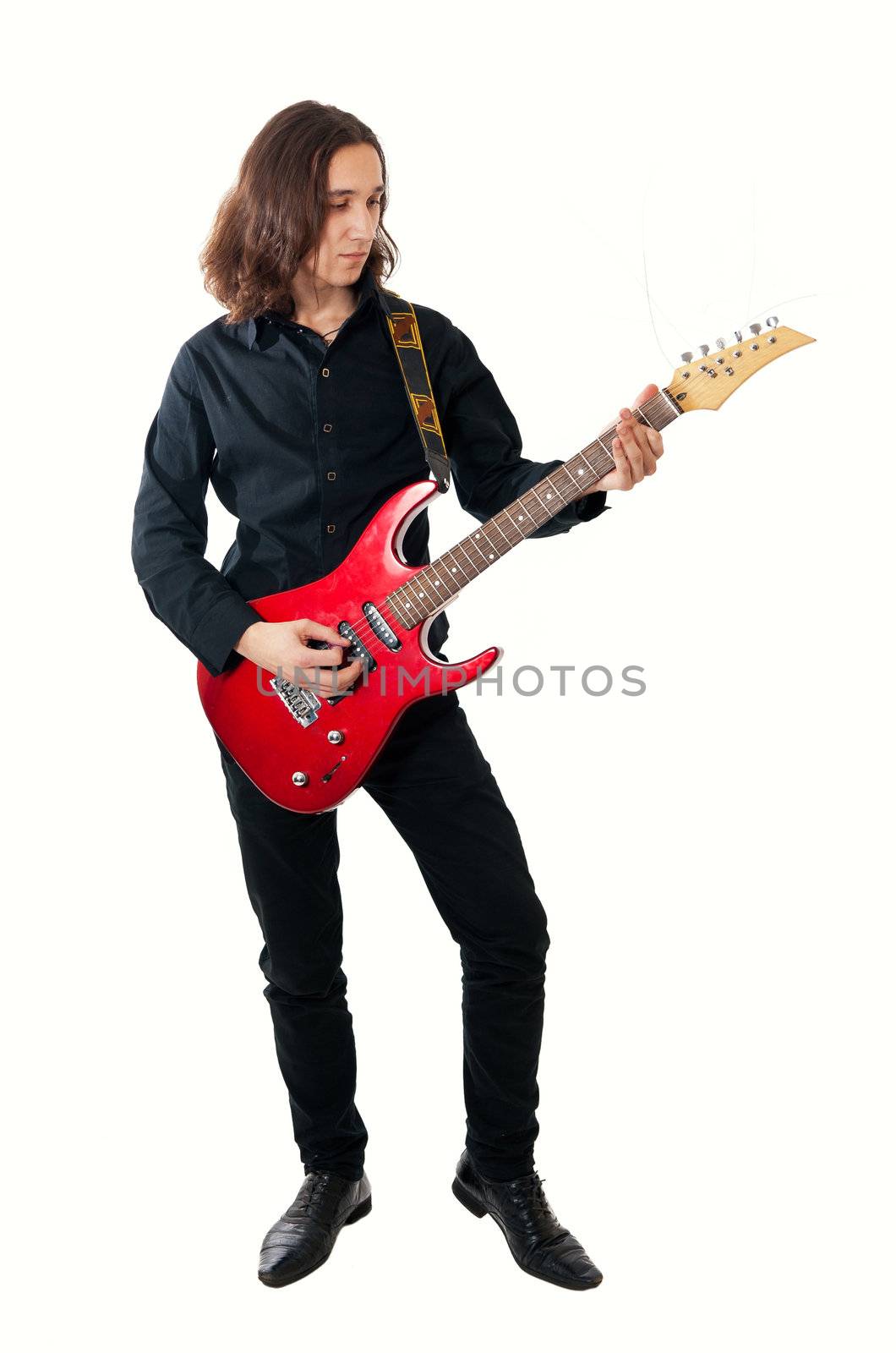 Young guitarist with red guitar on white background