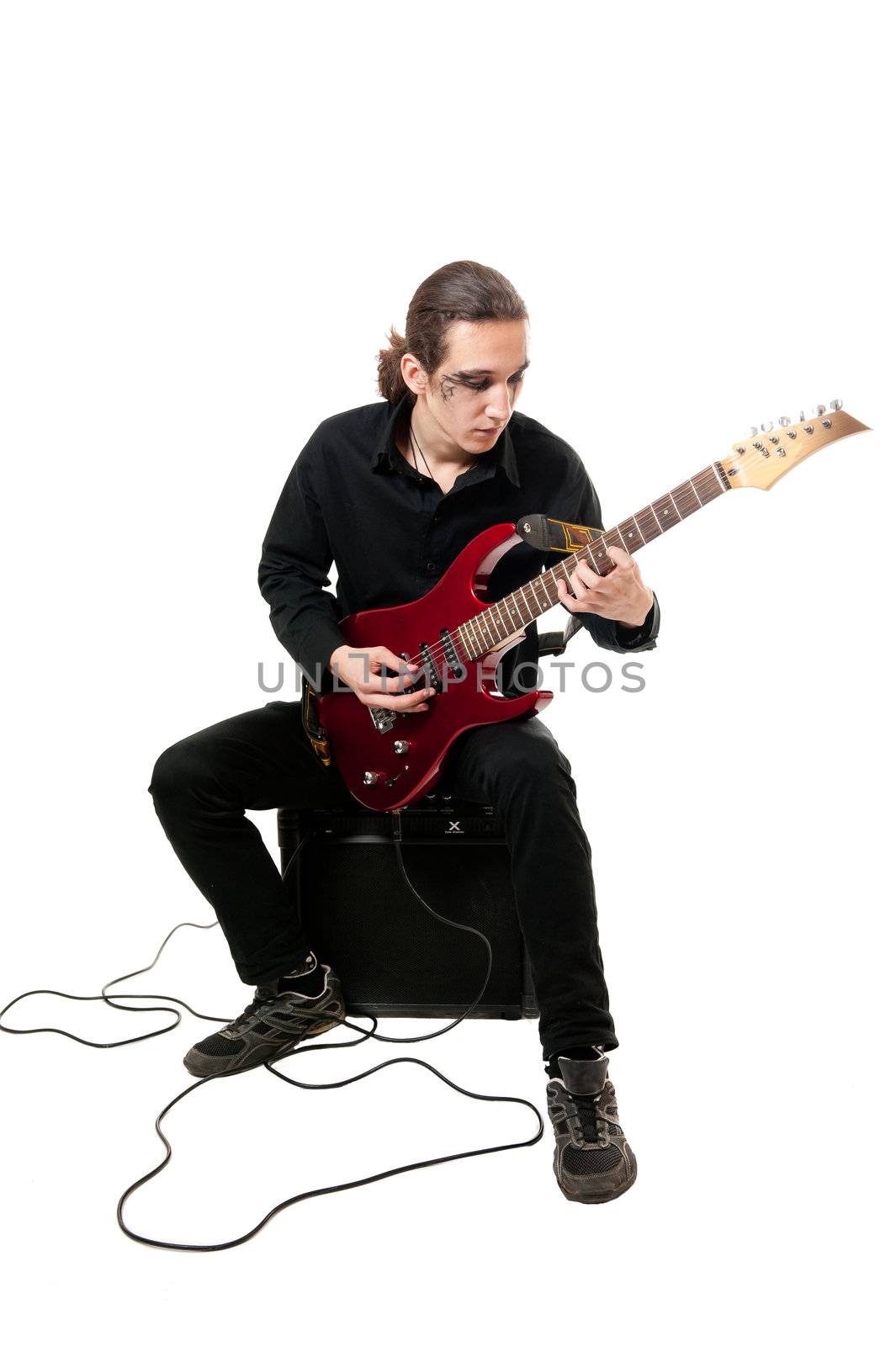 Young guitarist with red guitar on white background