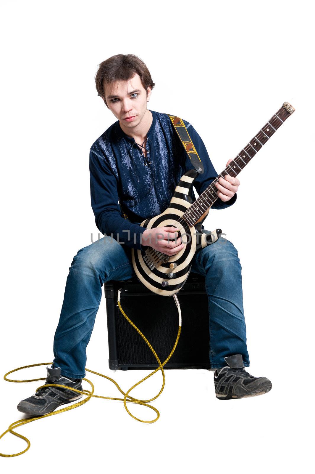 Young guitarist with electric guitar on white background