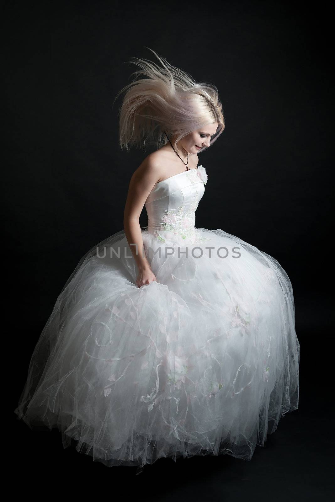 Beautiful girl in white dress on black background