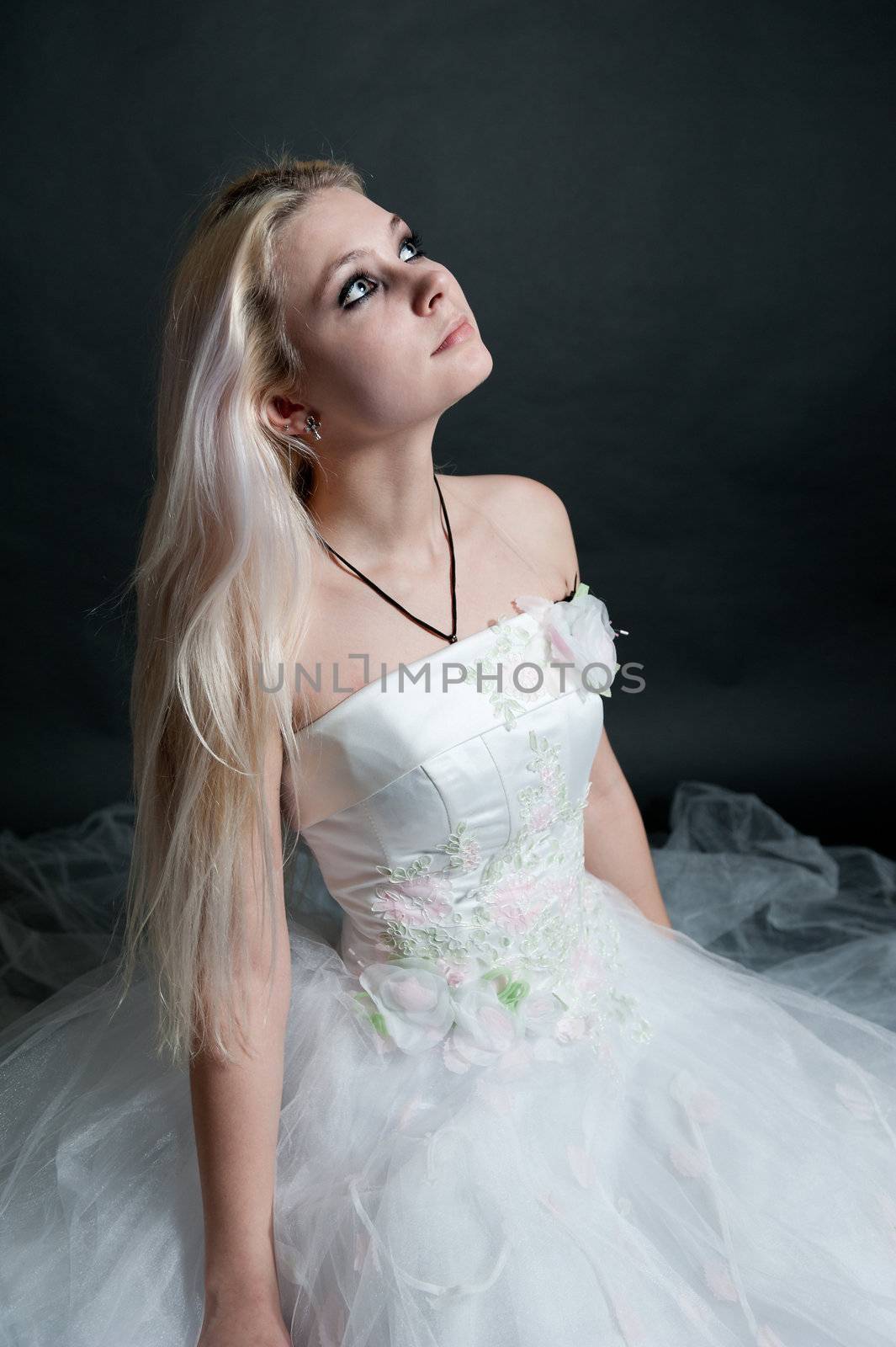 Beautiful girl in white dress on black background