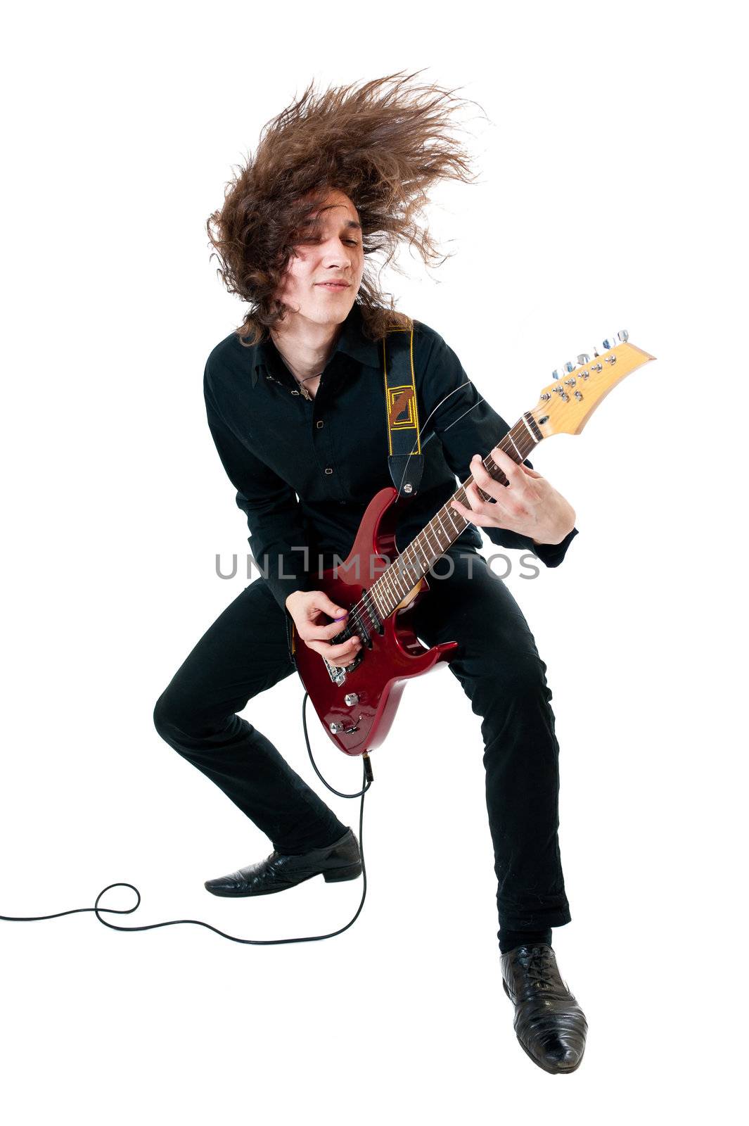 Young guitarist with red guitar on white background