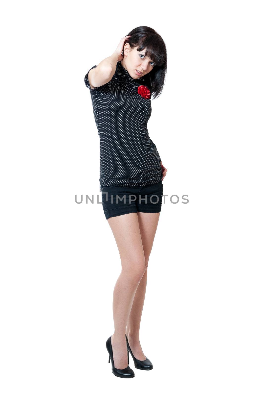 Young girl in black blouse and shorts isolated on white background