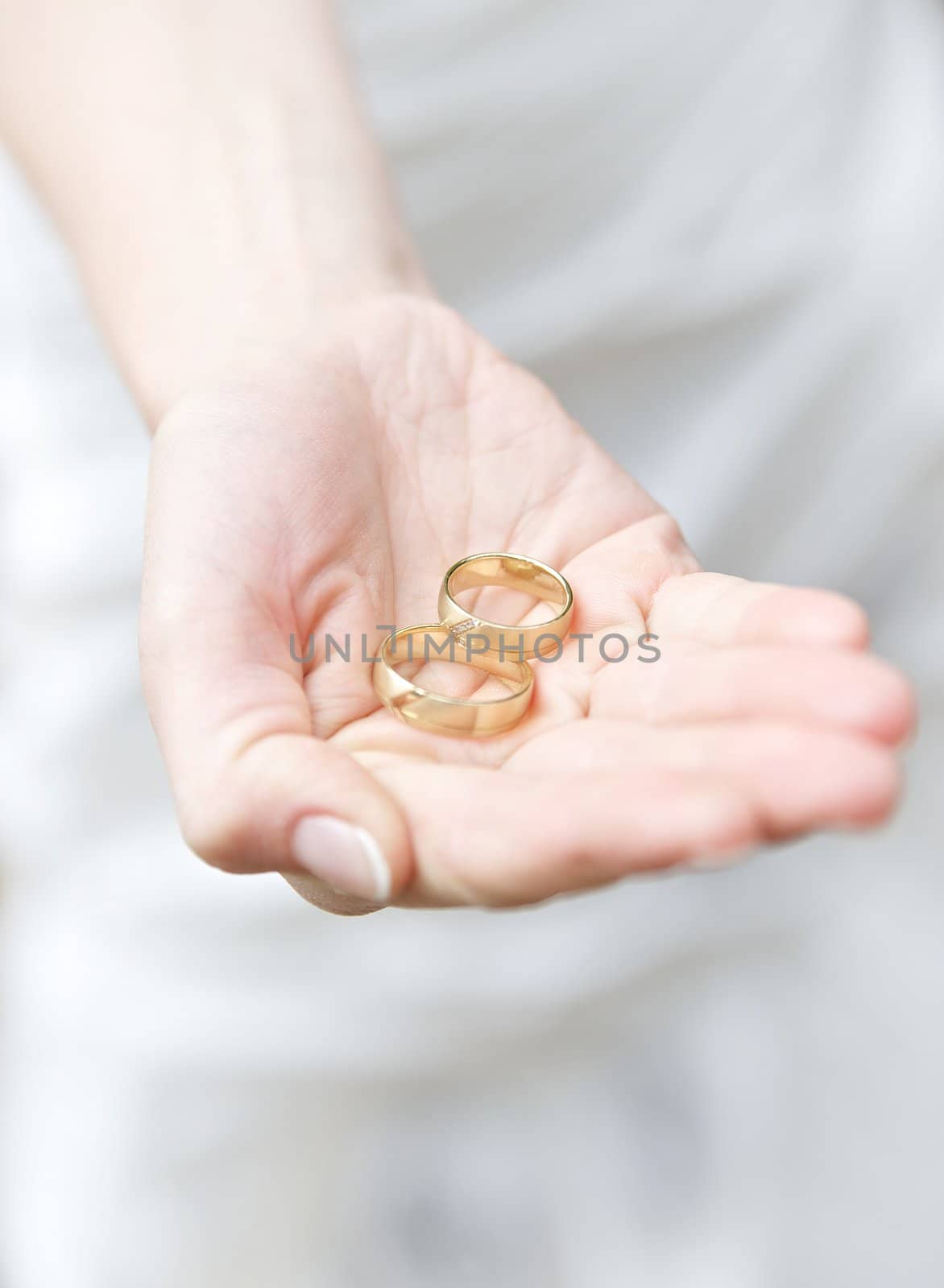 Wedding rings inside the hand of a bride