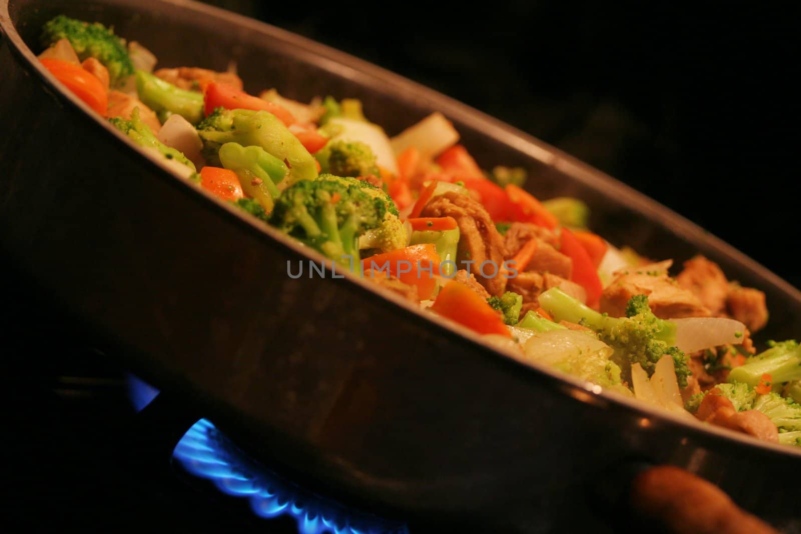 Chicken and vegetable stirfry in a wok;