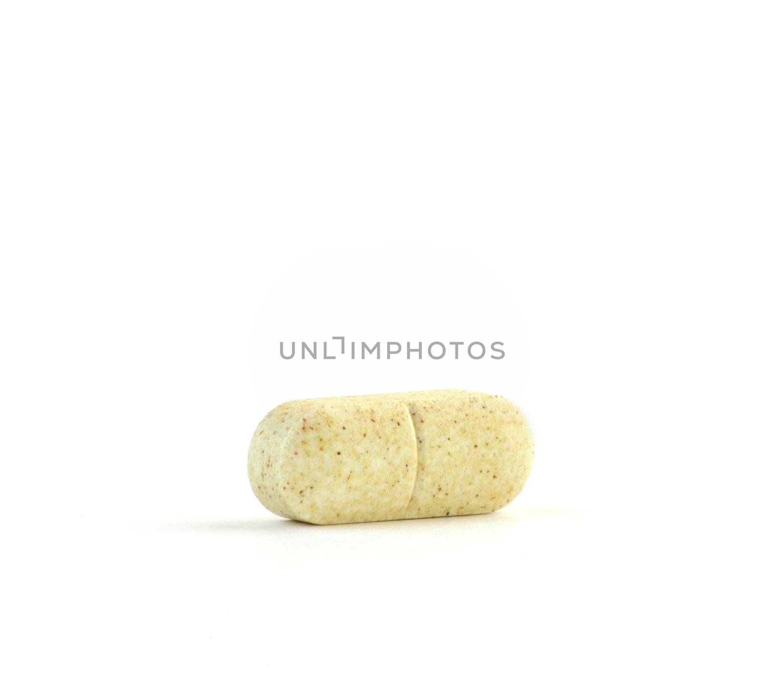 Speckled Vitamin C Tablet Isolated Against a Pure White Background