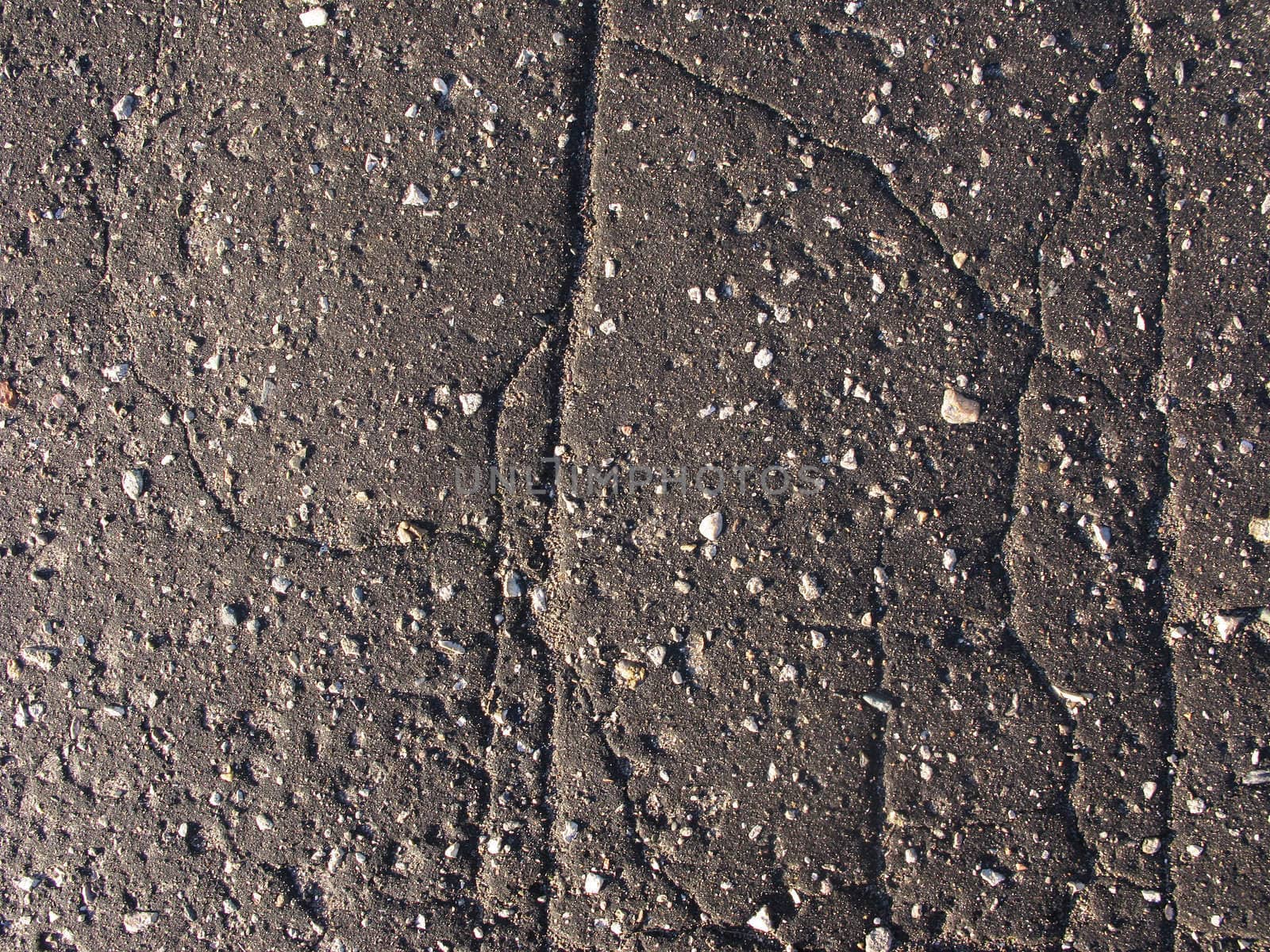 Old cracked asphalt road surface by wander
