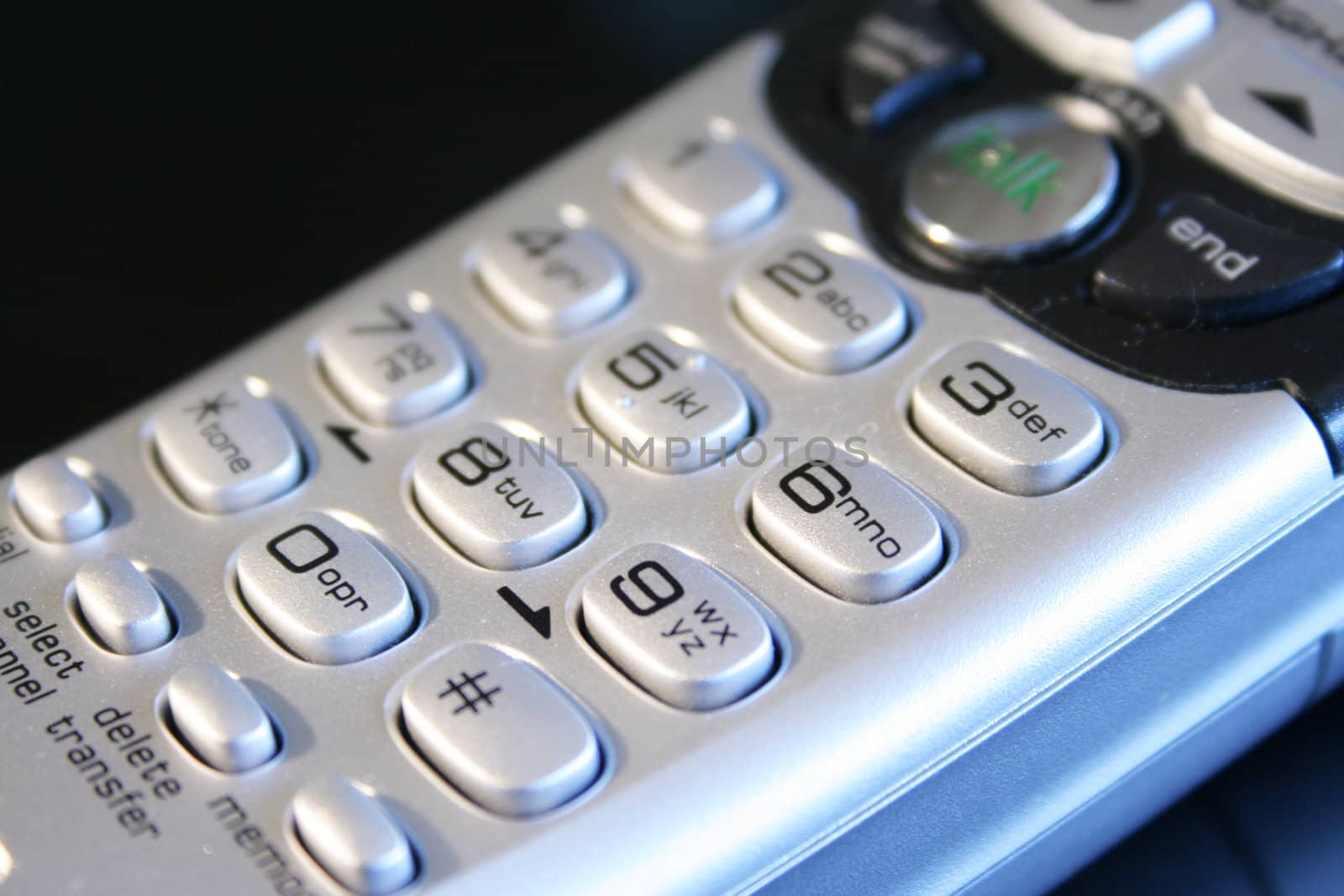 Close up of silver cordless telephone keypad.;