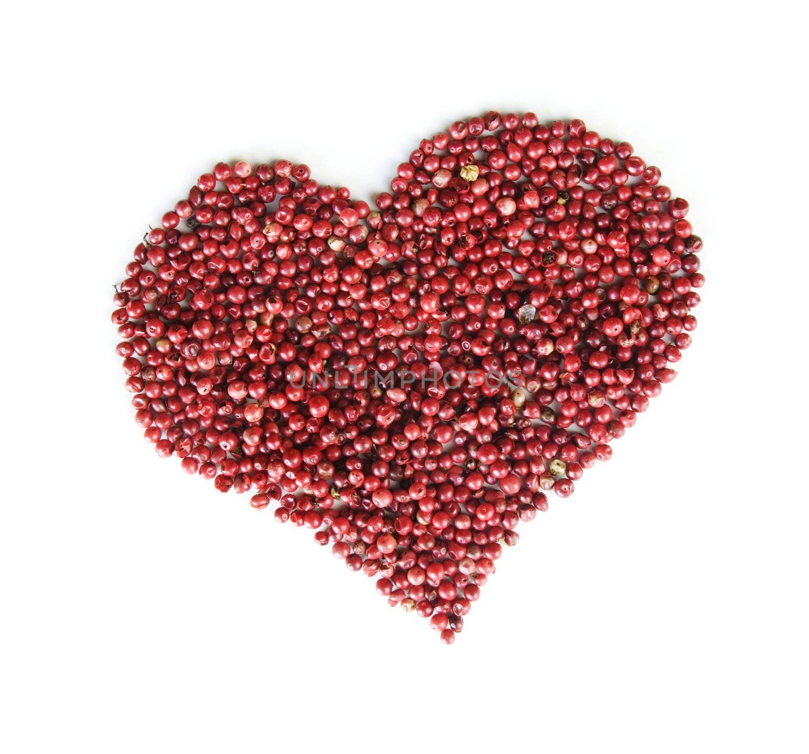 Red rose peppers form a heart isolated on a white background