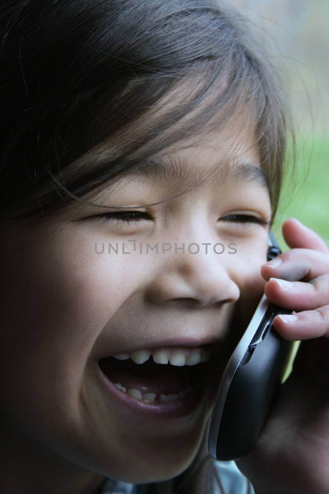 Six year old girl talking on cell phone.; by jarenwicklund