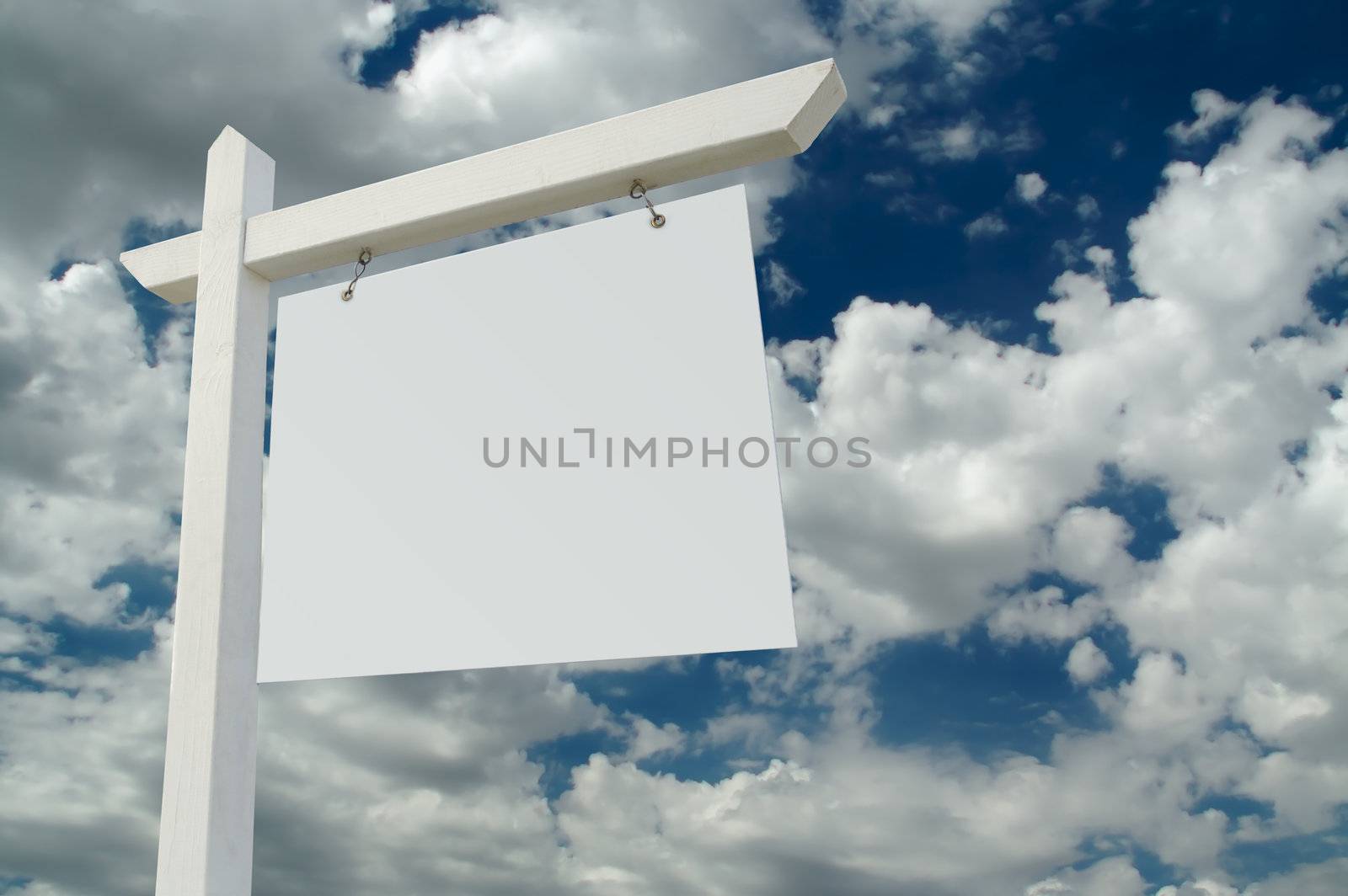 Blank Real Estate Sign on Clouds & Sky Background - Ready for your own message.