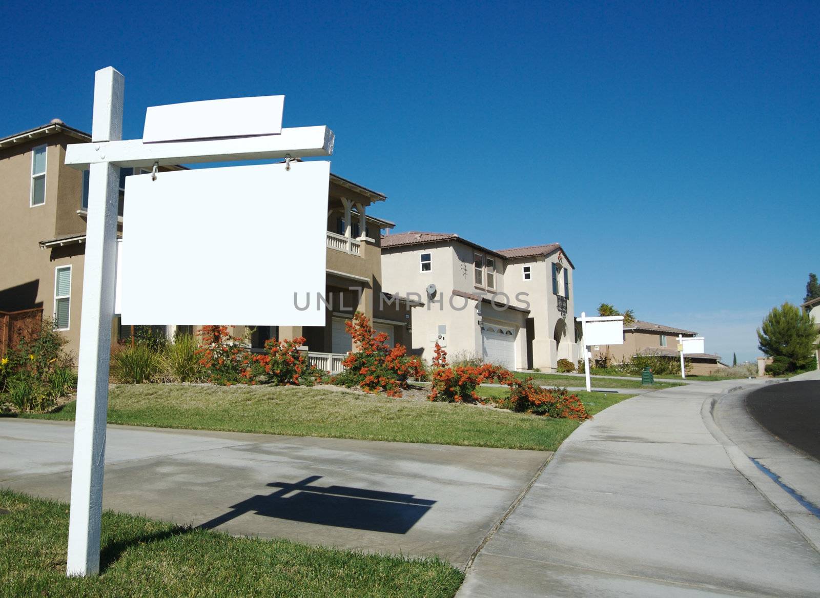 Blank Real Estate Sign in Front of Beautiful New Home