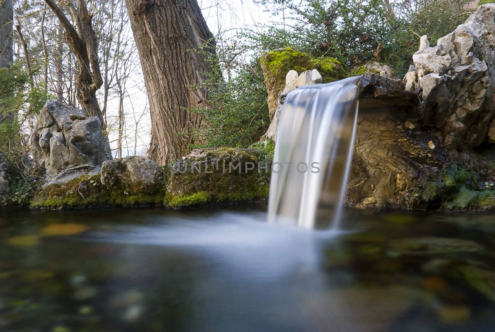 long exposure photo of an water spring with small waterfall