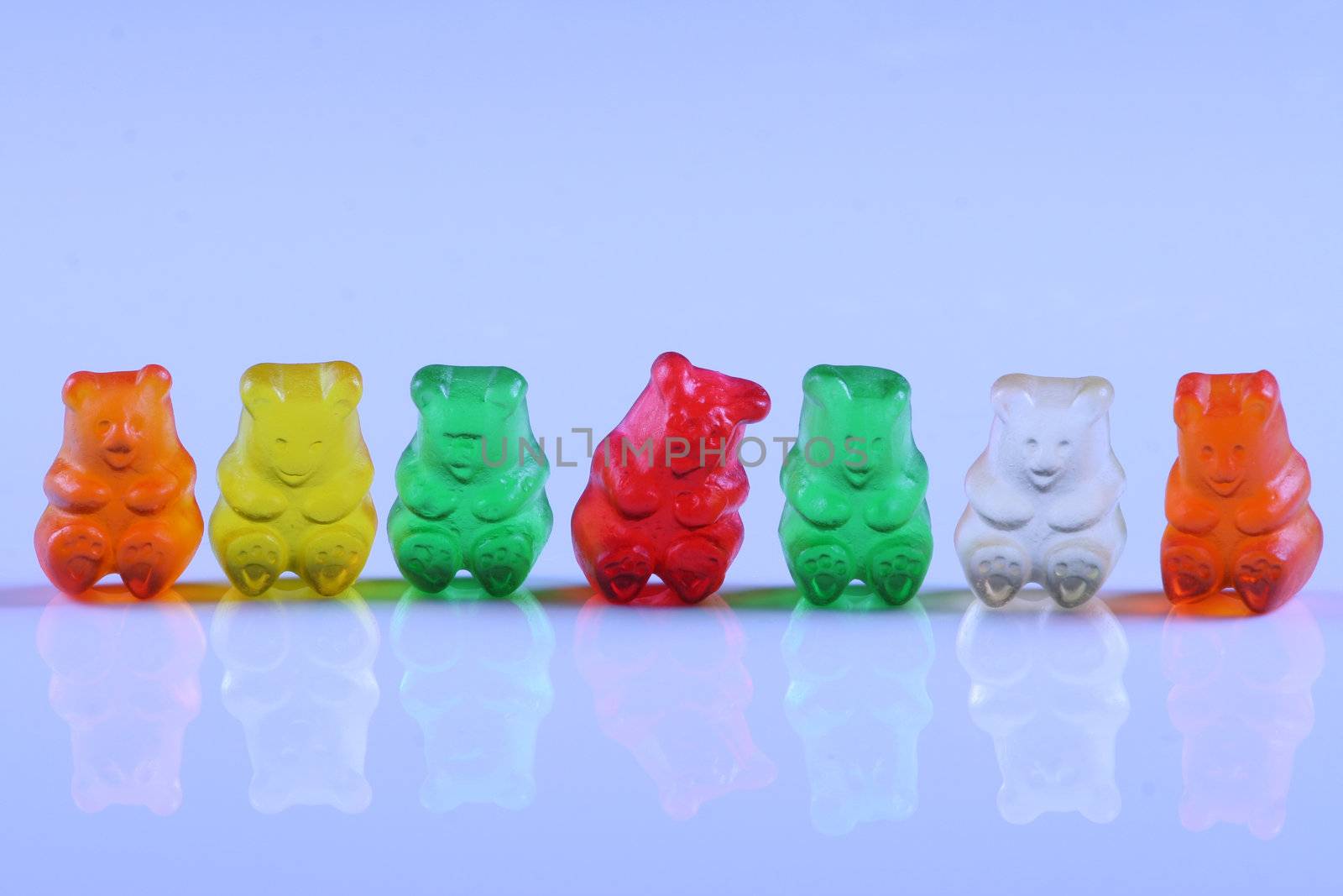 Colorful gummy bears lined up in rows; by jarenwicklund