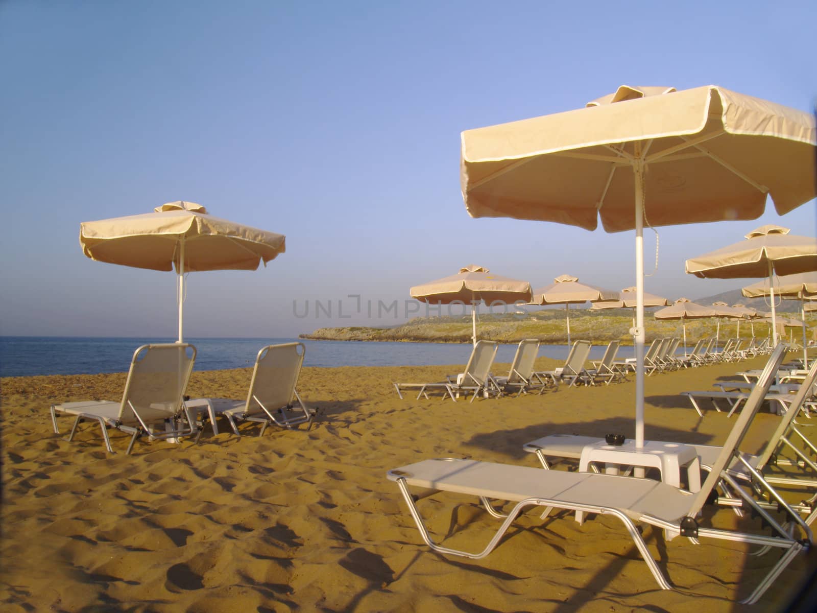 empty sunbeds on the beach