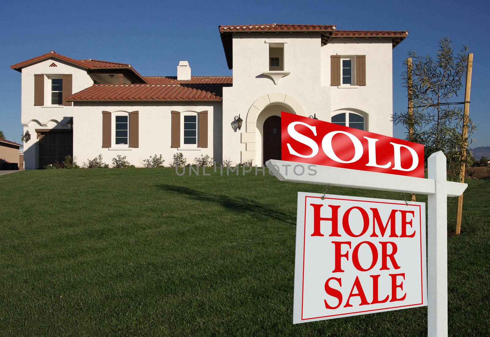 Sold Home For Sale Sign in Front of New House
