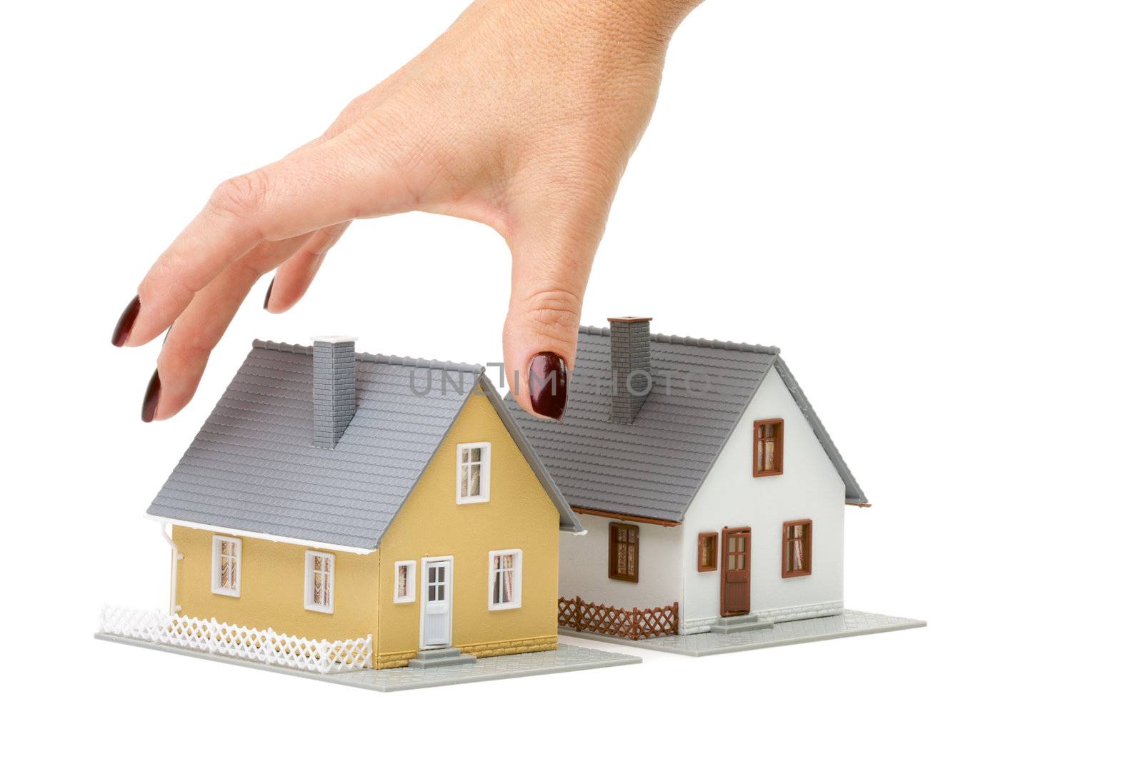 Female hand reaching for house isolated on a white background.