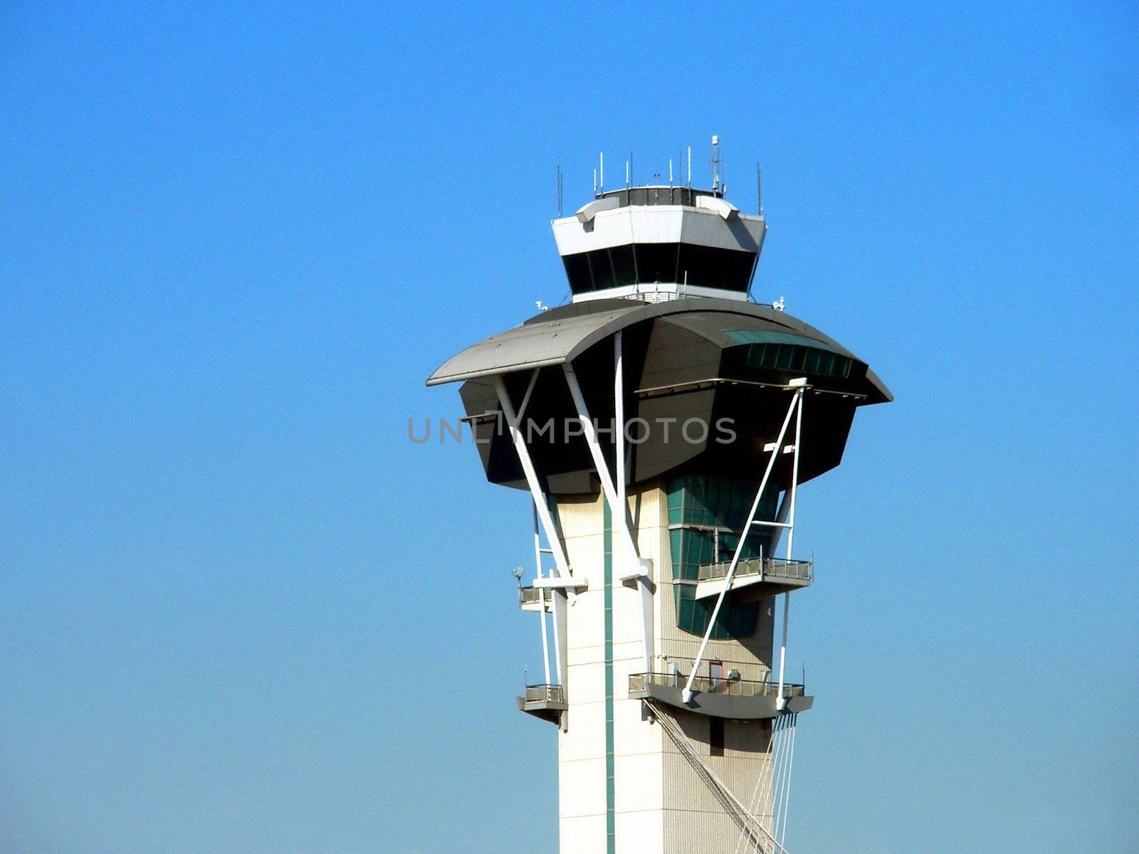 Control Tower at an airport with blue sky in background.