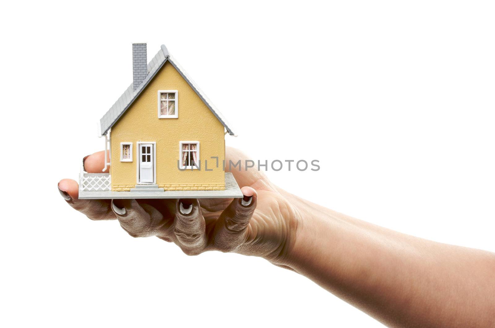 Female hand holding a house isolated on a white background.