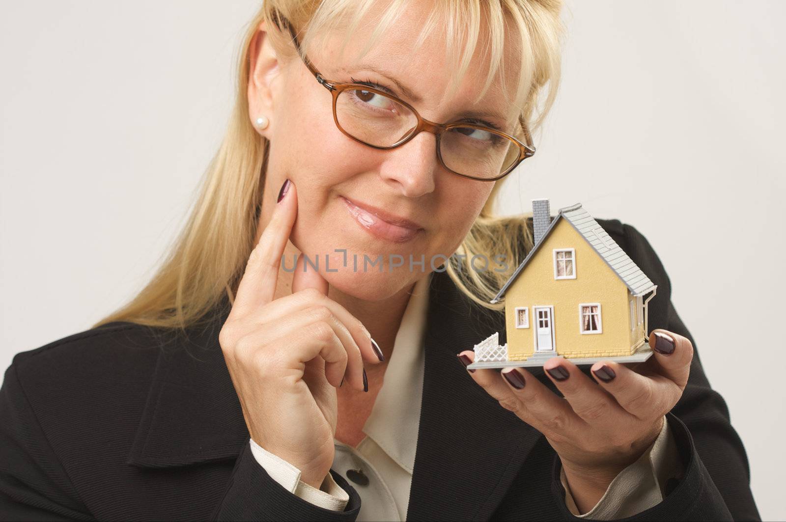 Female holding small house.