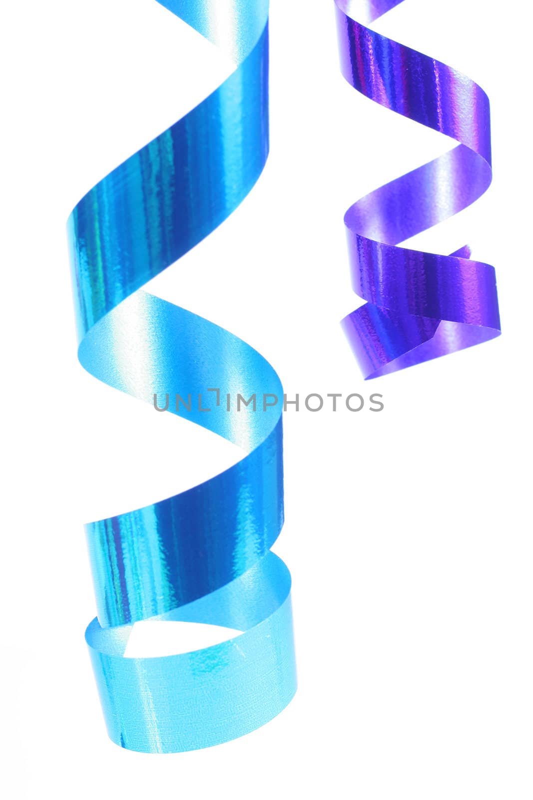 Shiny colorful satin ribbons hanging in curls. Holiday, celebration, party theme.