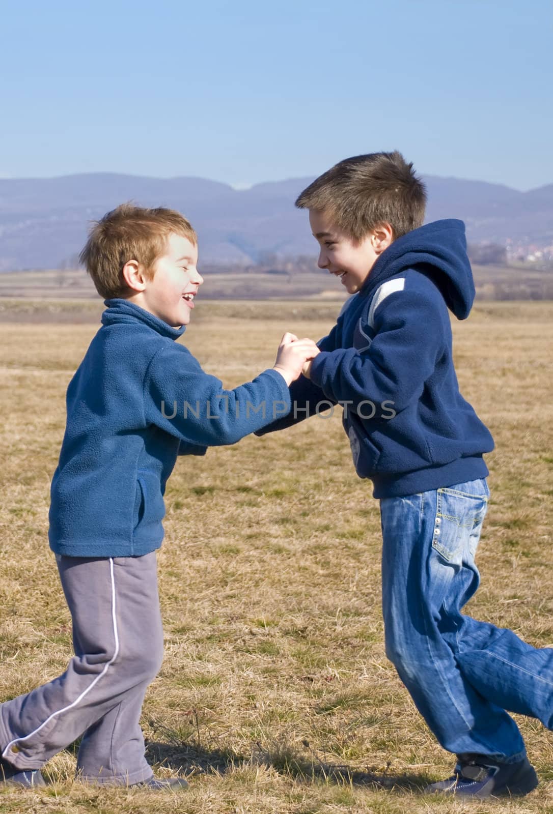 two boy meet each other outside and laugh