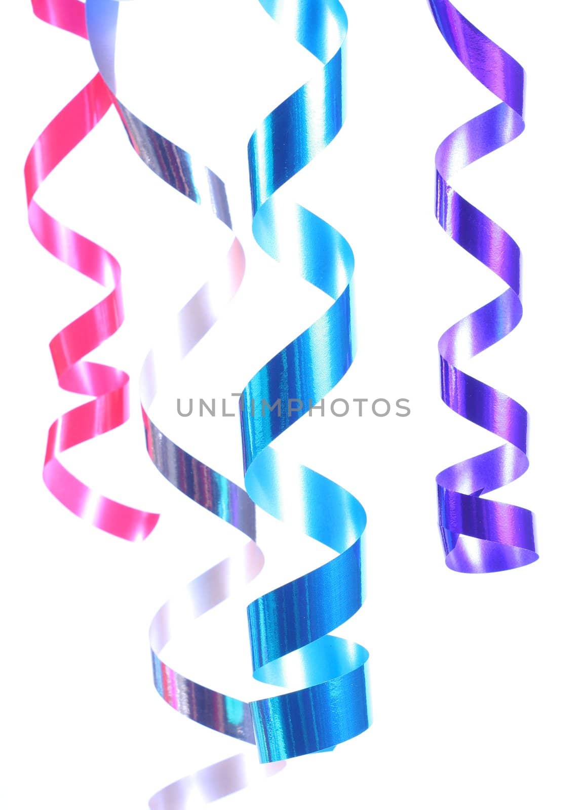 Shiny colorful satin ribbons hanging in curls. Holiday, celebration, party theme.